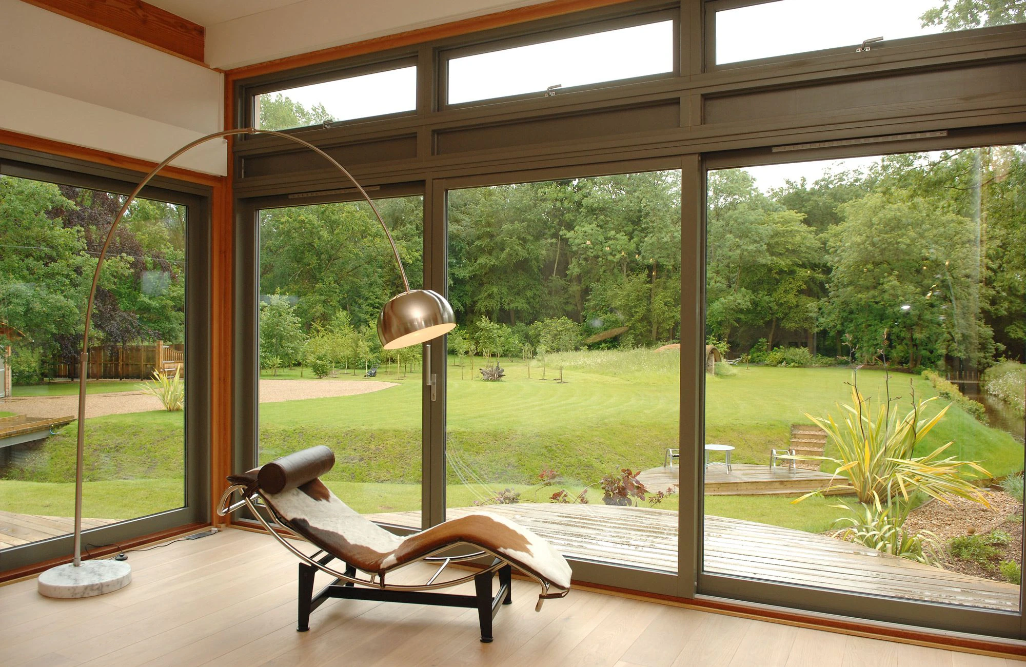 Douglas Fir-Framed Living Space with Expansive Glazing Showcasing Panoramic Countryside Views