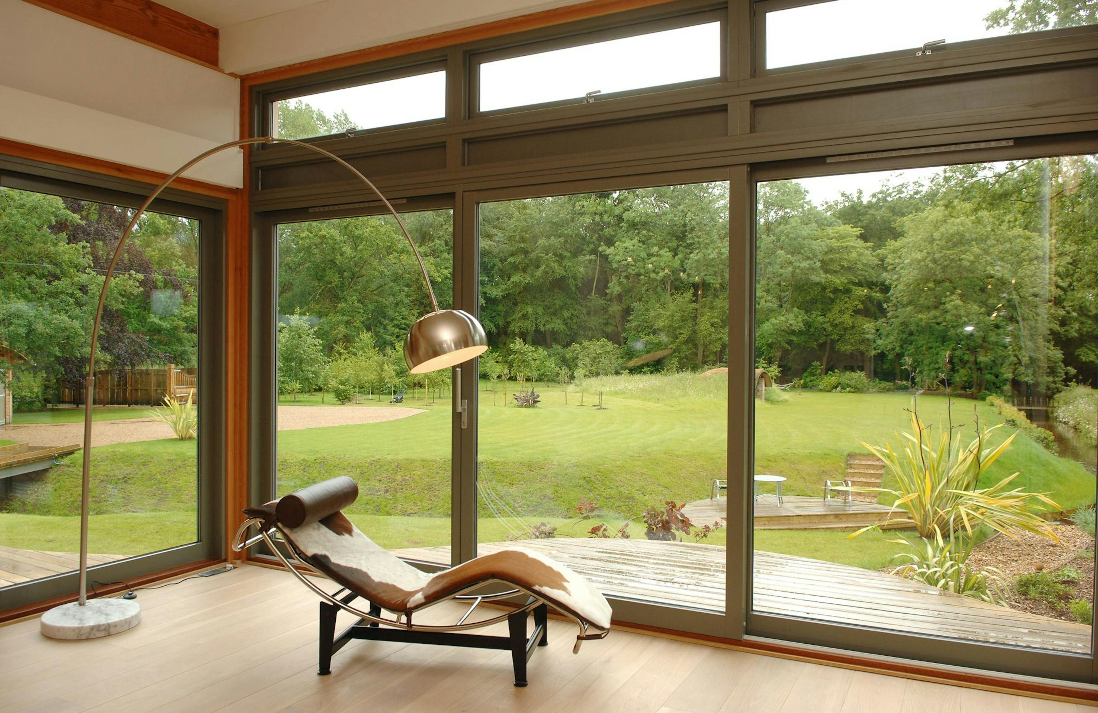 Douglas Fir-Framed Living Space with Expansive Glazing Showcasing Panoramic Countryside Views