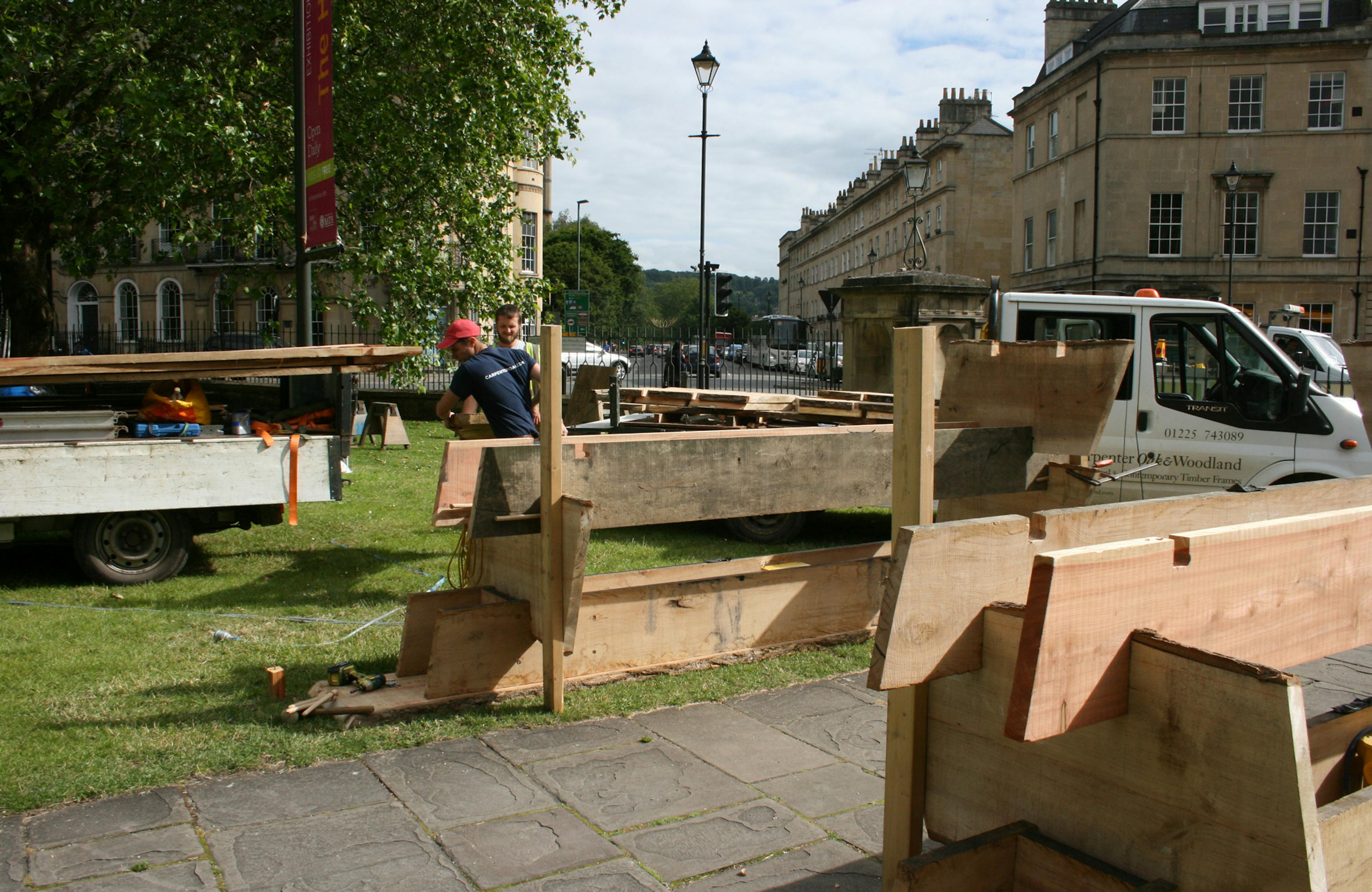 Carpenters install a wooden structure for the forest of imagination festival in Bath in 2019