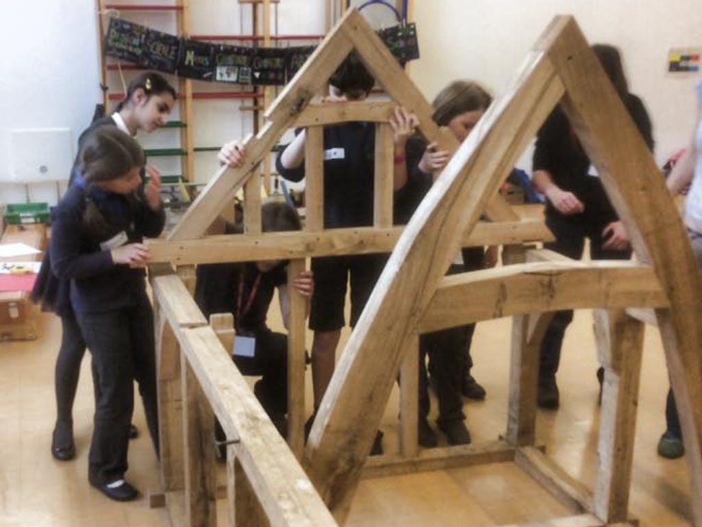 Astrid Arnold female carpenter in a school teaching children about carpentry and timber framing