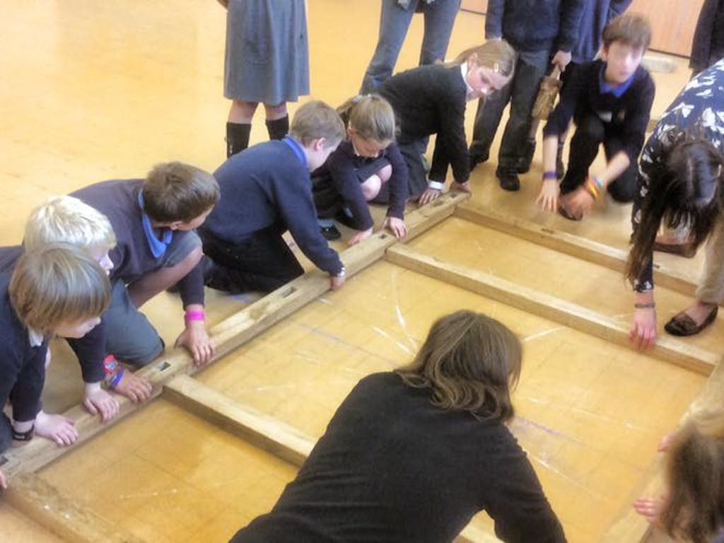 Astrid Arnold female carpenter in a school teaching children about carpentry and timber framing