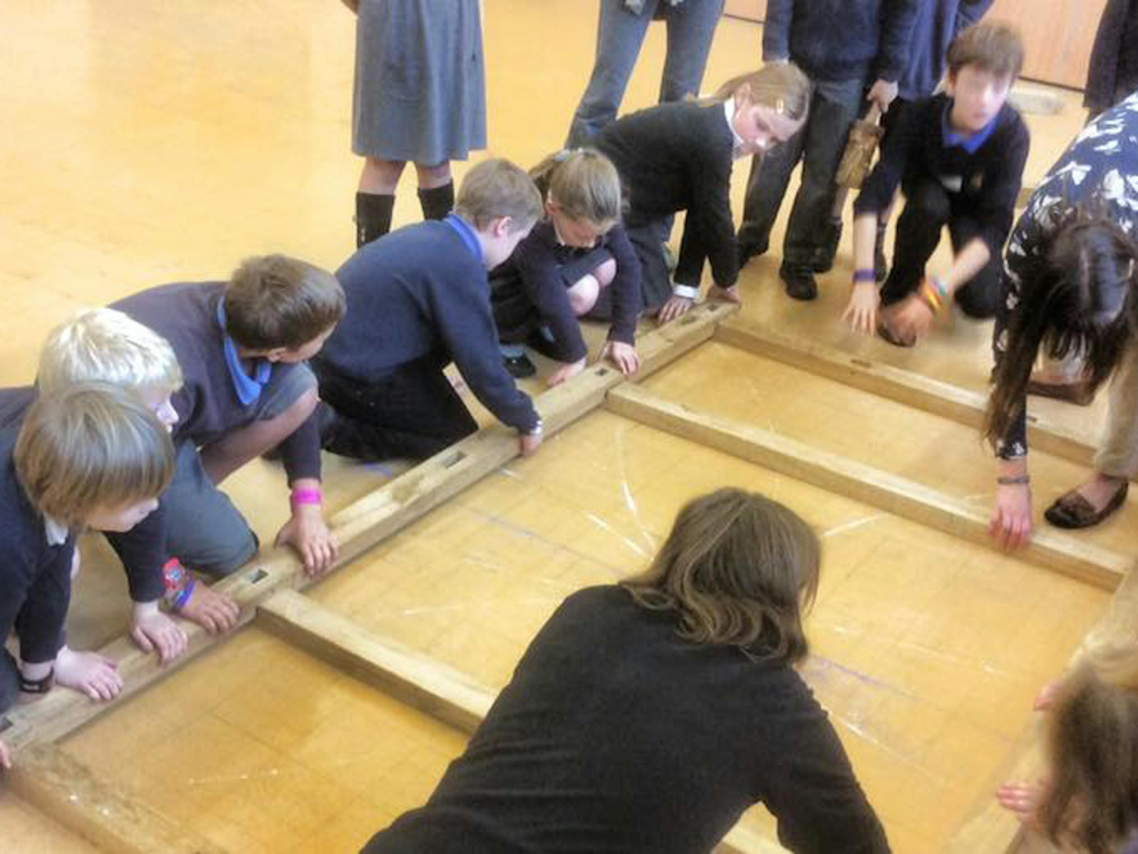 Astrid Arnold female carpenter in a school teaching children about carpentry and timber framing