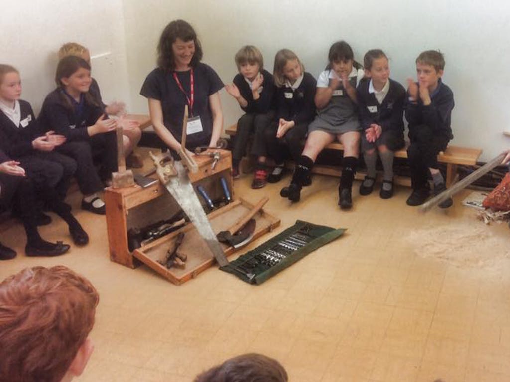 Astrid Arnold female carpenter in a school teaching children about carpentry and timber framing