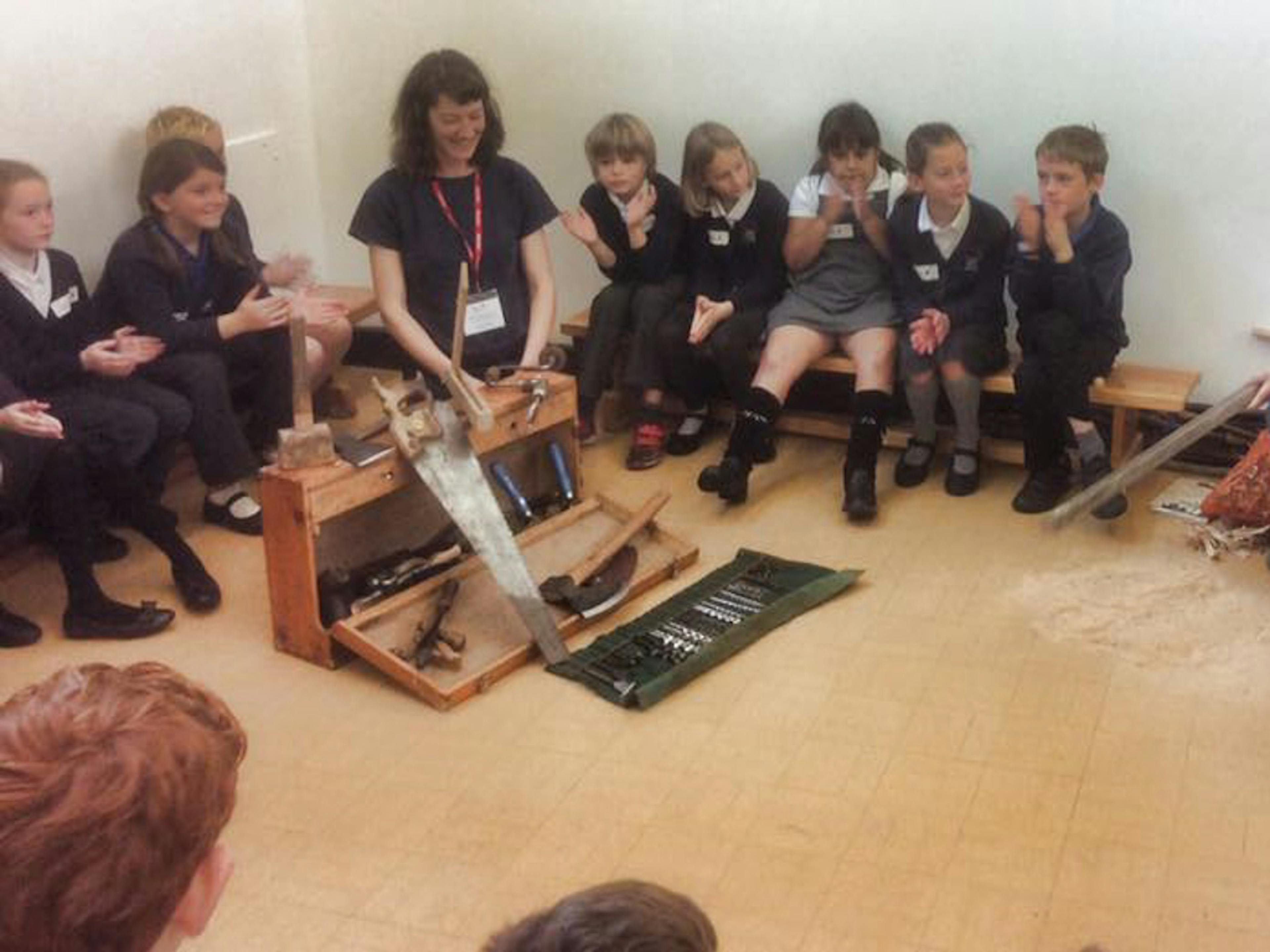 Astrid Arnold female carpenter in a school teaching children about carpentry and timber framing