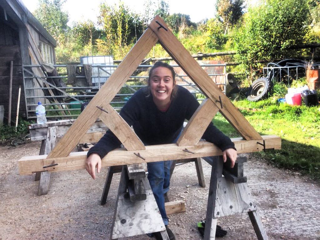 Astrid Arnold and female carpenters building a mini timber frame house