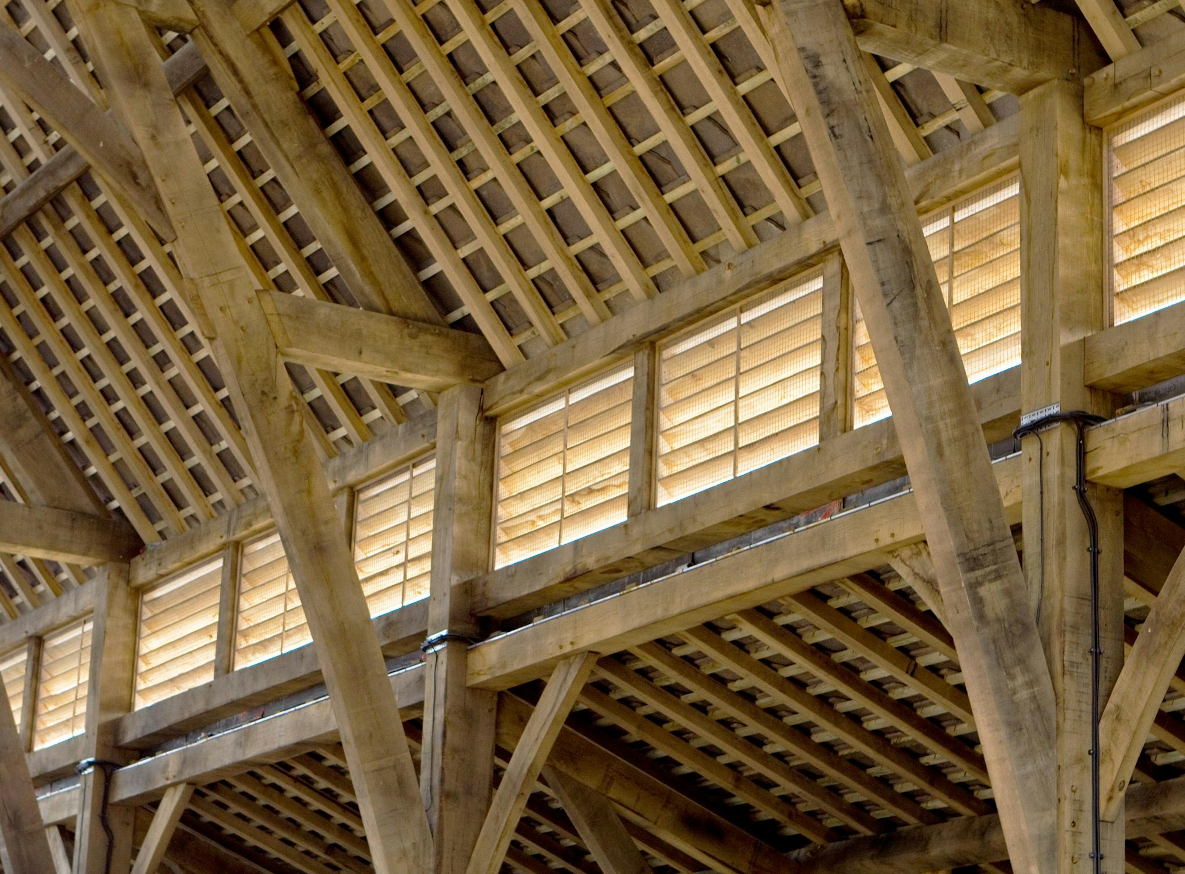 Close-up of the timber structure inside Penistone Market, highlighting the craftsmanship and intricate joinery of the green oak frame