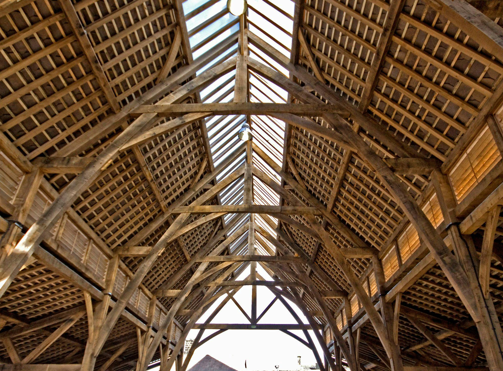Internal view of a green oak frame structure at Penistone Market in Yorkshire, highlighting the intricate timber beams and traditional craftsmanship