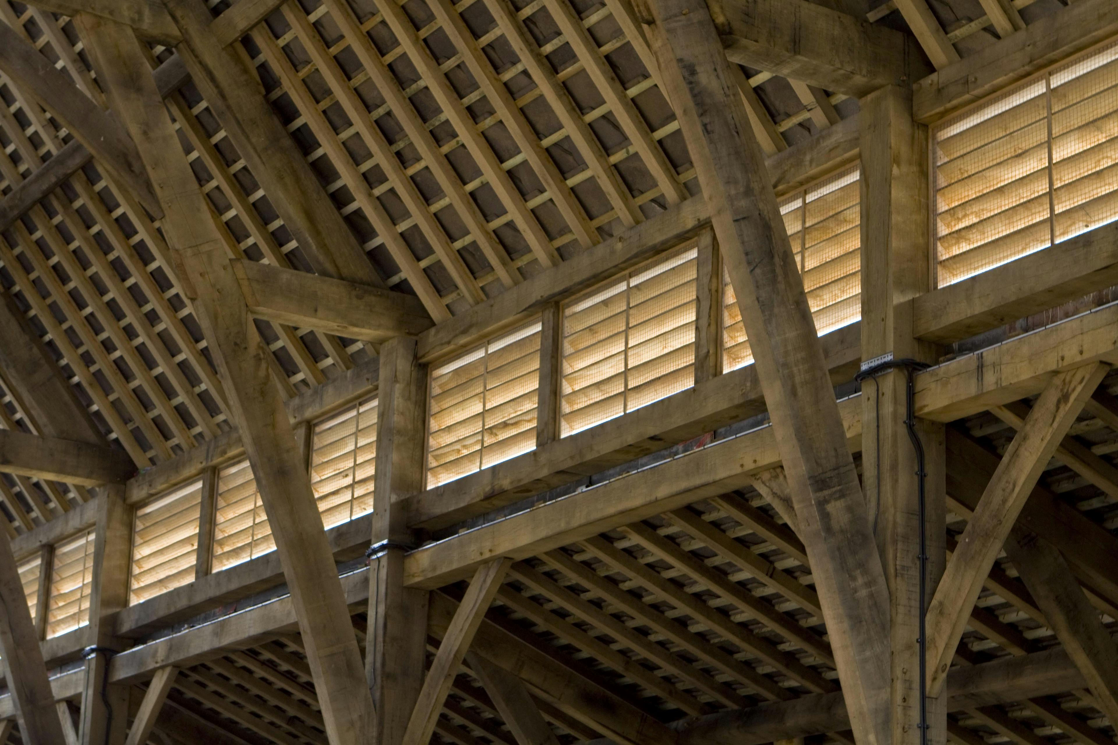Close-up of the timber structure inside Penistone Market, highlighting the craftsmanship and intricate joinery of the green oak frame