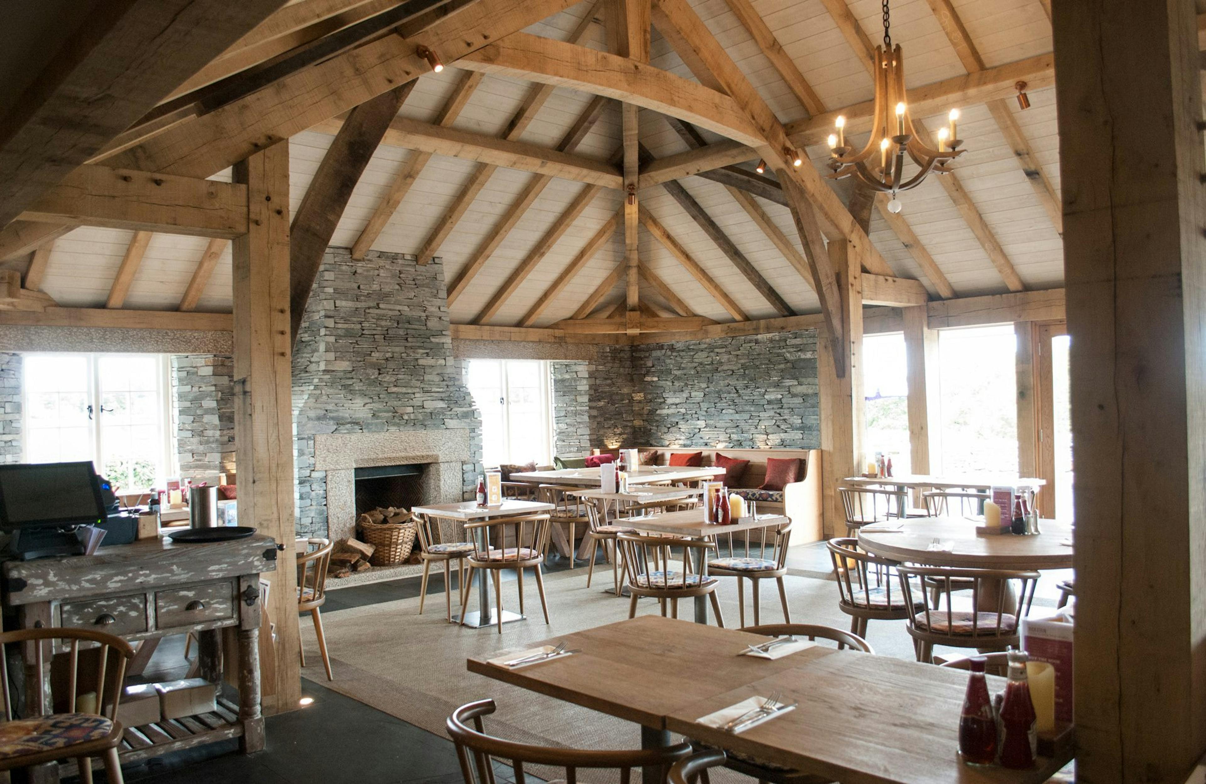 Internal view of Rick Stein's Cornish Arms pub, featuring a spacious oak frame structure with rustic beams and warm, inviting decor