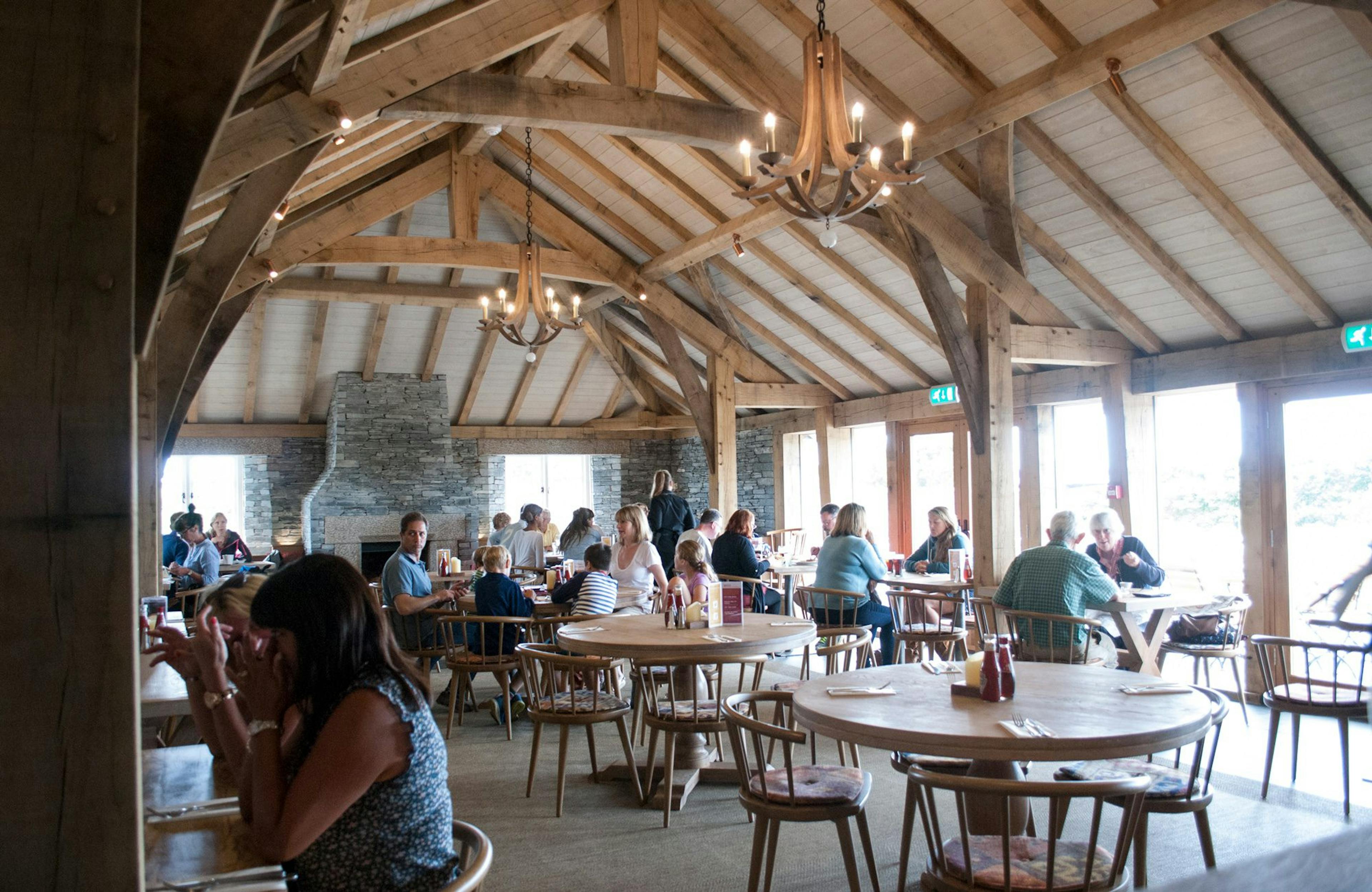 Internal view of Rick Stein's Cornish Arms pub, featuring a spacious oak frame structure and central fireplace