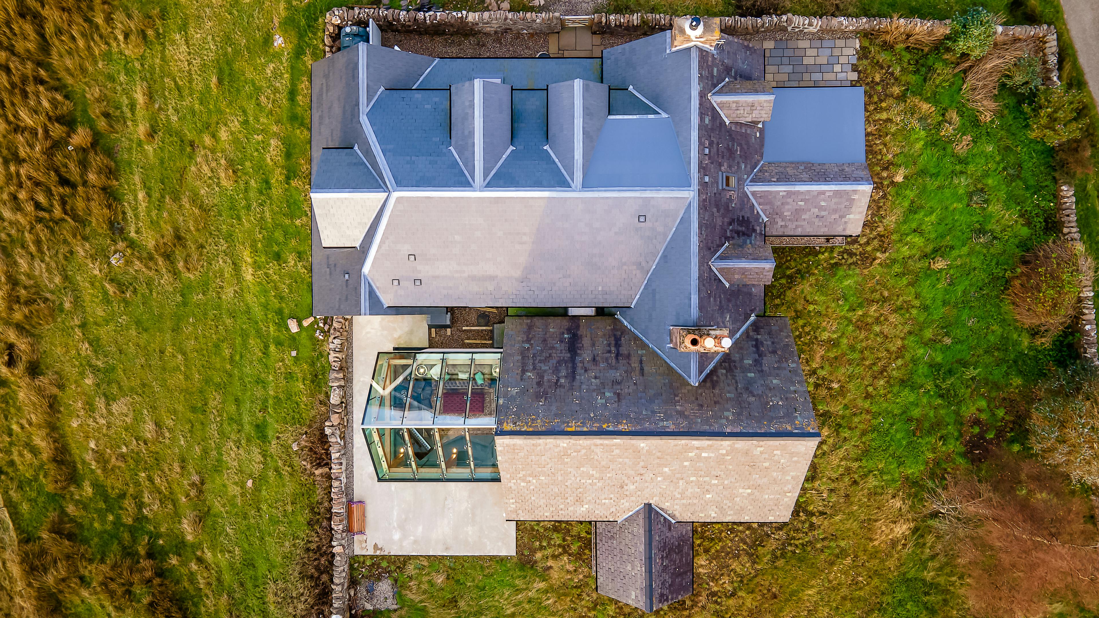 Aerial view of a cottage with a glazed extension