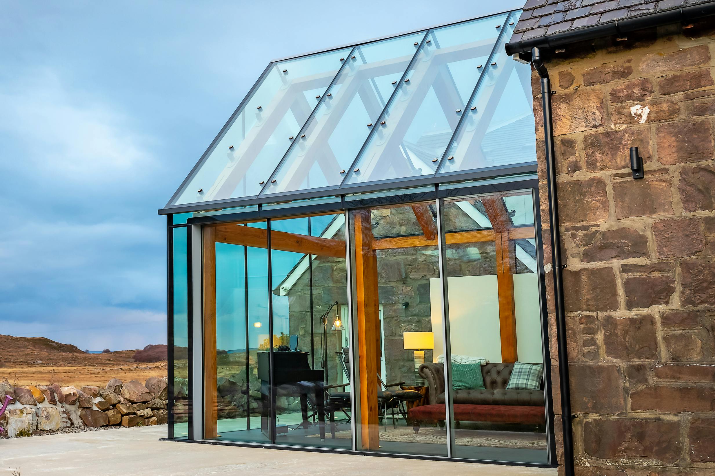 Glazed extension with an internal timber-framed structure offering panoramic views of the surrounding moorland