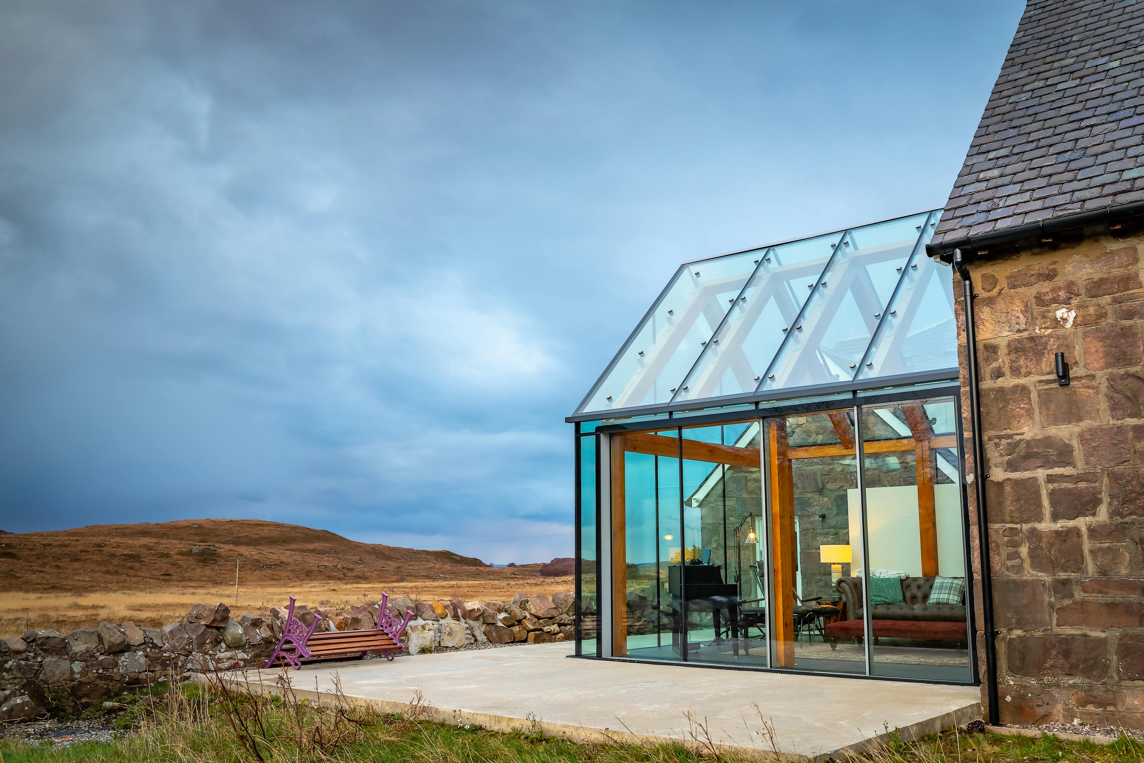 Glazed extension with an internal timber-framed structure offering panoramic views of the surrounding moorland