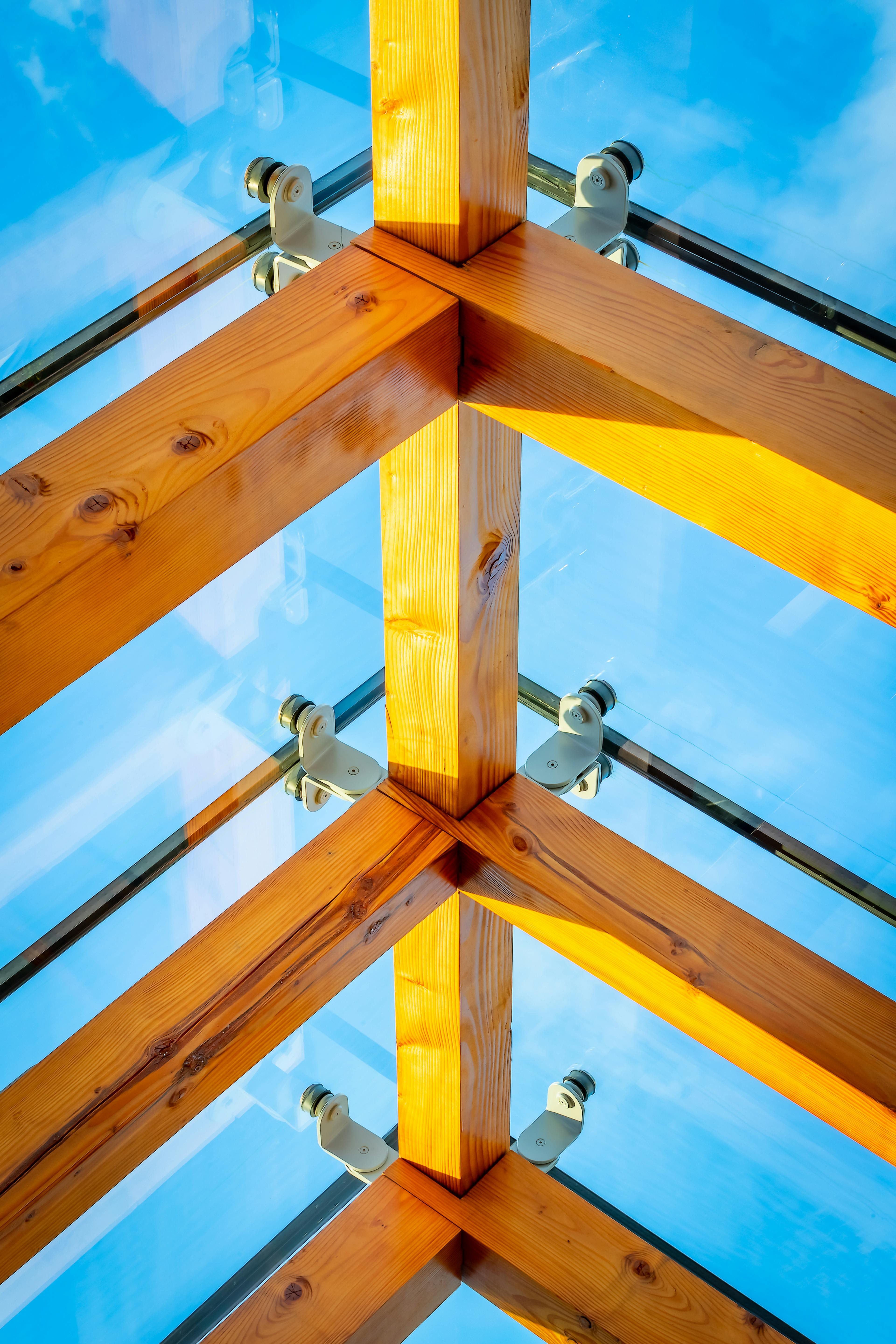 Close-up of a Douglas fir structural timber frame enclosed by glazing