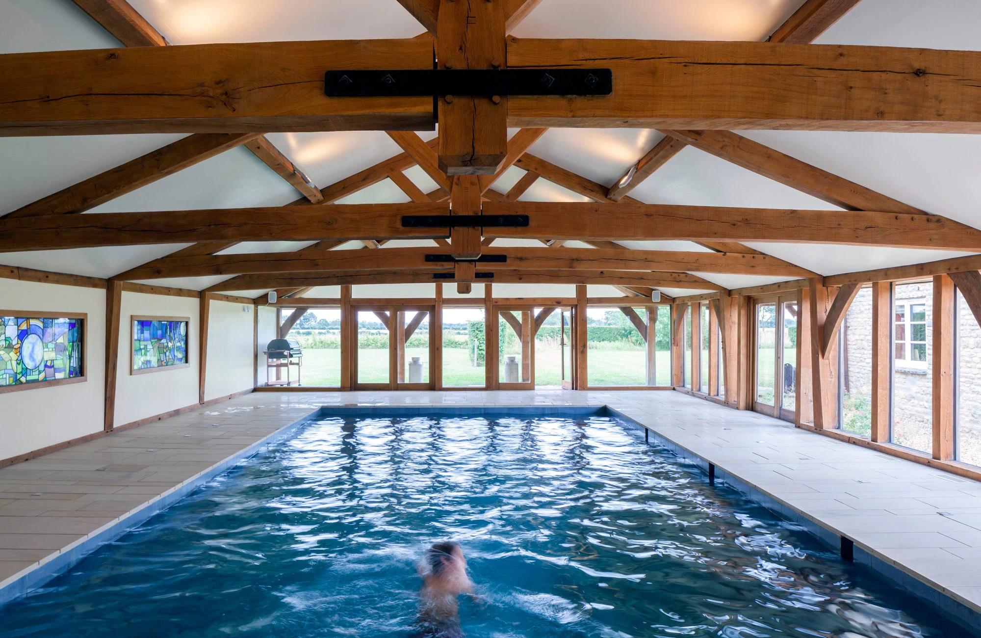 Internal view of a swimming pool with a structural timber frame