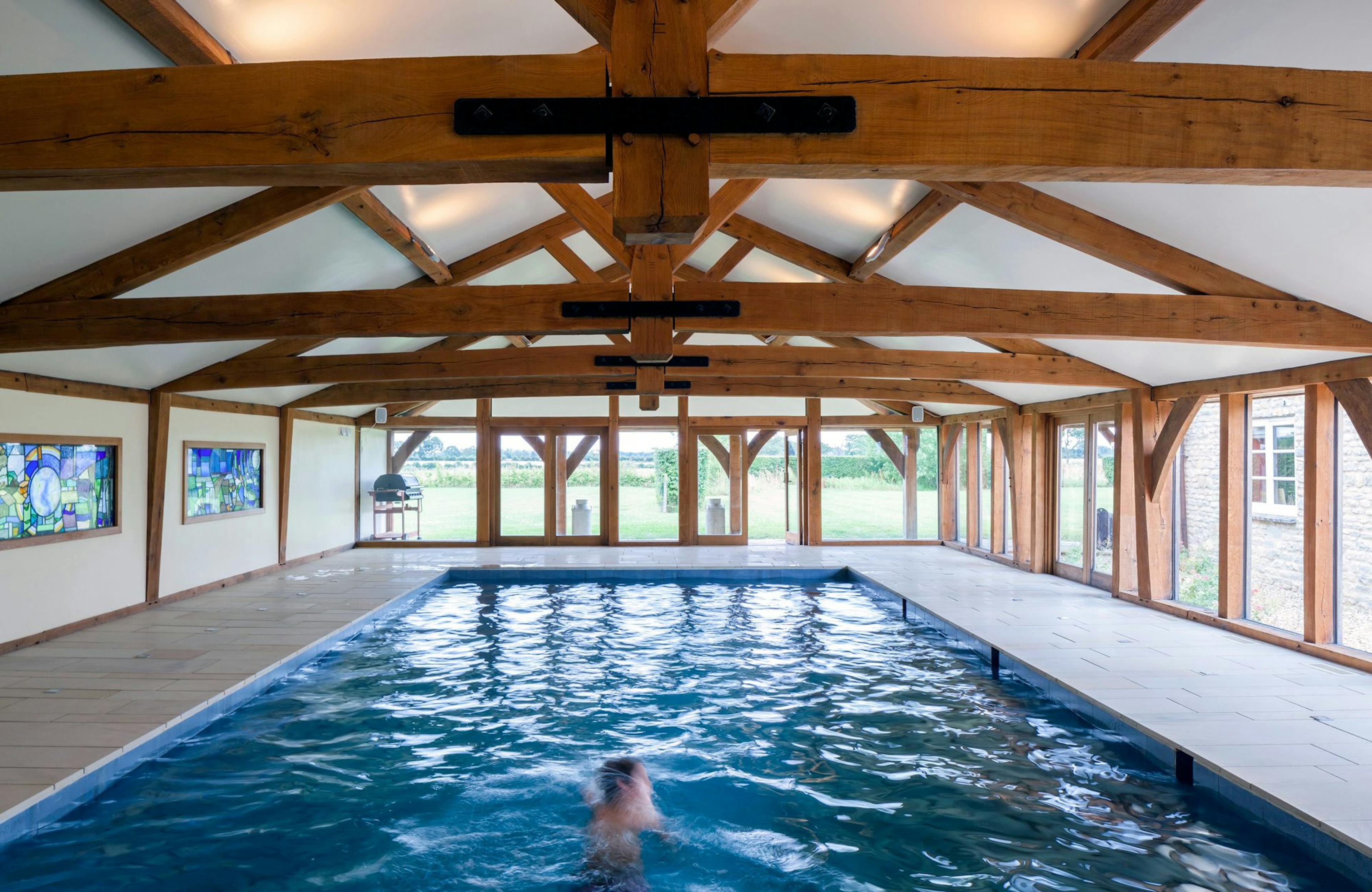 Internal view of a swimming pool with a structural timber frame