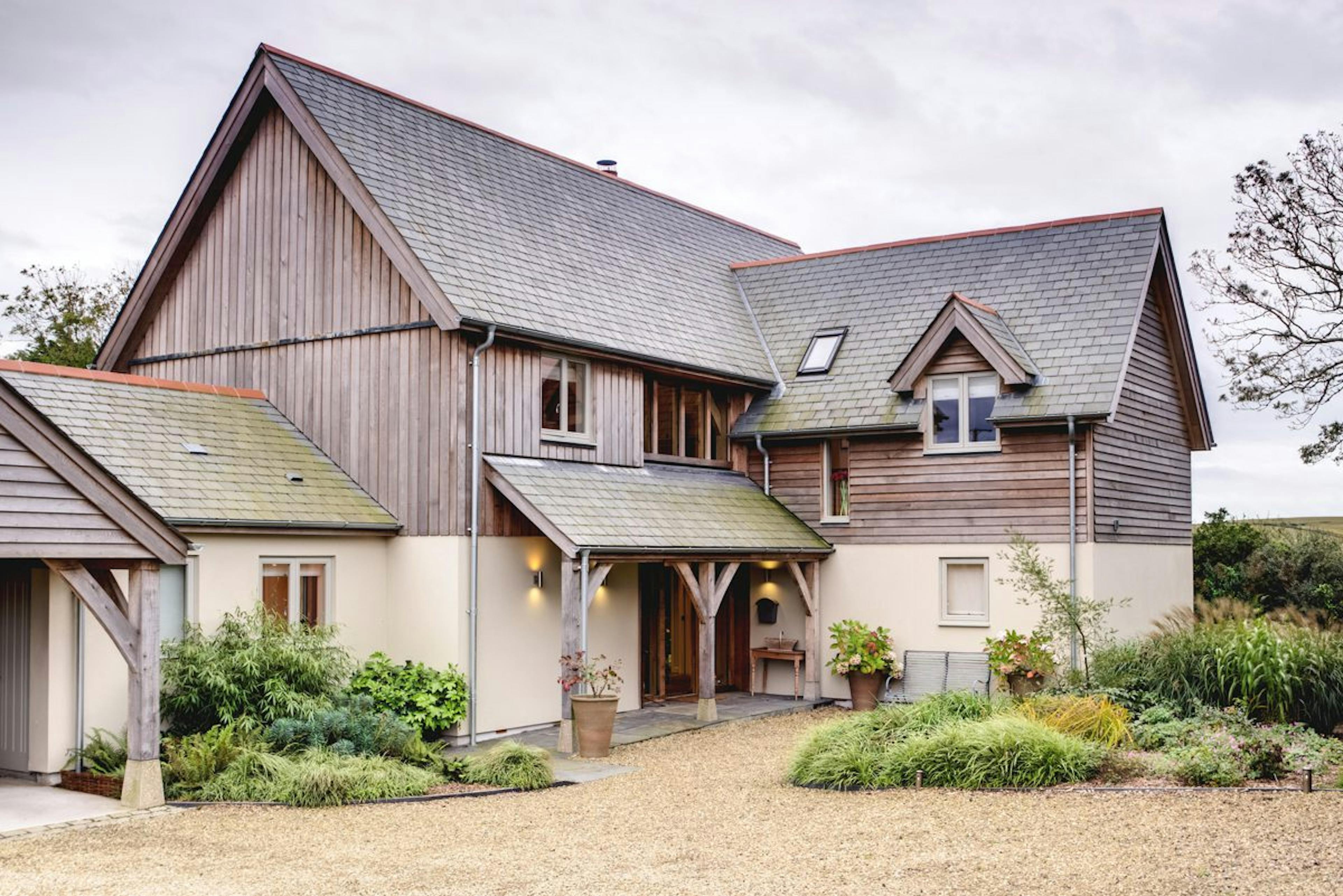 The entrance of a Cornish oak-framed farmhouse, showcasing traditional craftsmanship and rustic charm