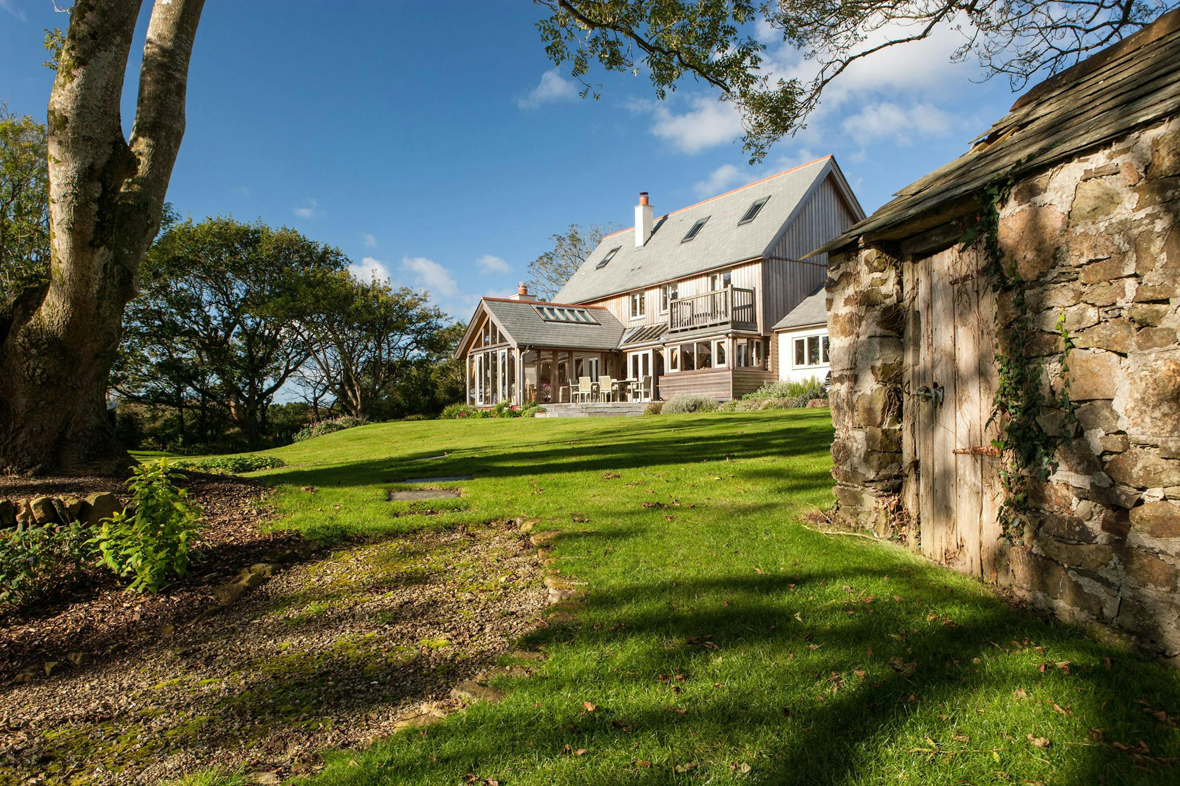 An oak-framed family home nestled in a picturesque garden setting