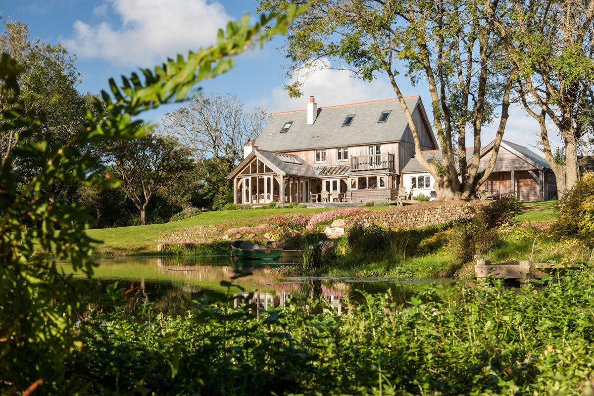 A Cornish oak-framed farmhouse nestled in the countryside, blending traditional design with rural charm