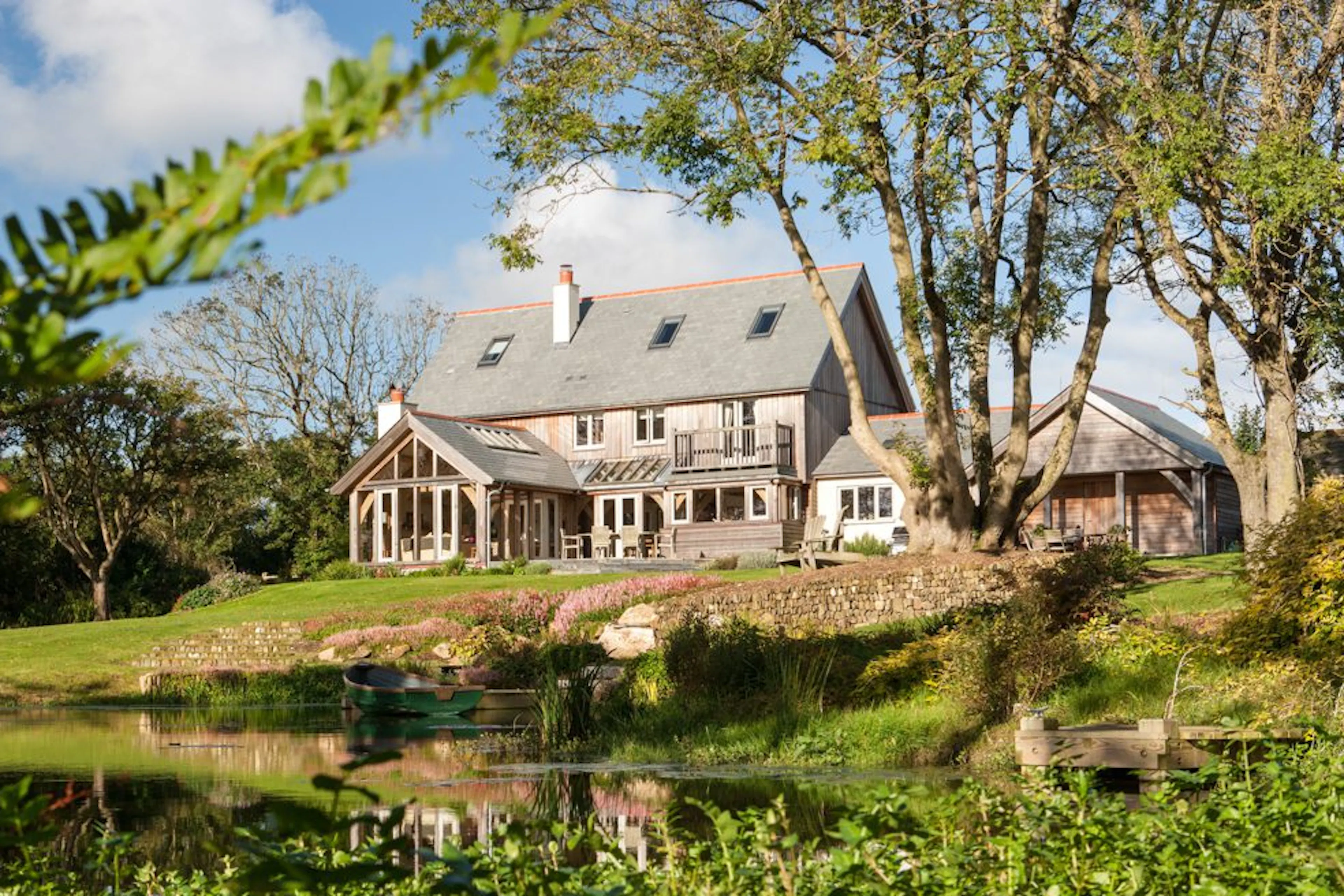 A Cornish oak-framed farmhouse nestled in the countryside, blending traditional design with rural charm