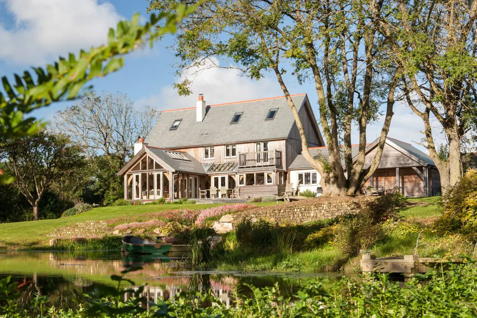 A Cornish oak-framed farmhouse nestled in the countryside, blending traditional design with rural charm