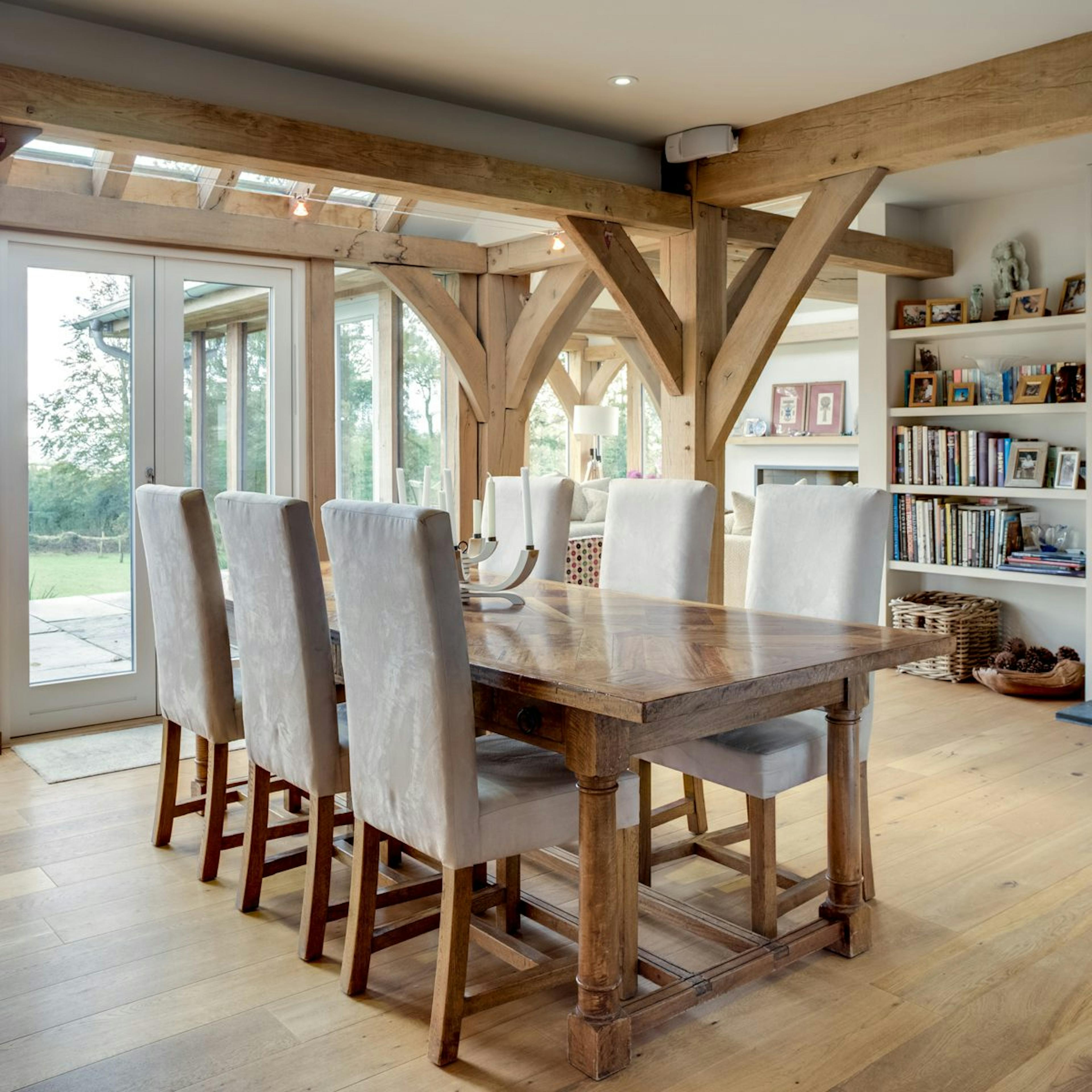 An oak-framed open-plan kitchen and dining room, featuring rustic charm and a warm, inviting atmosphere