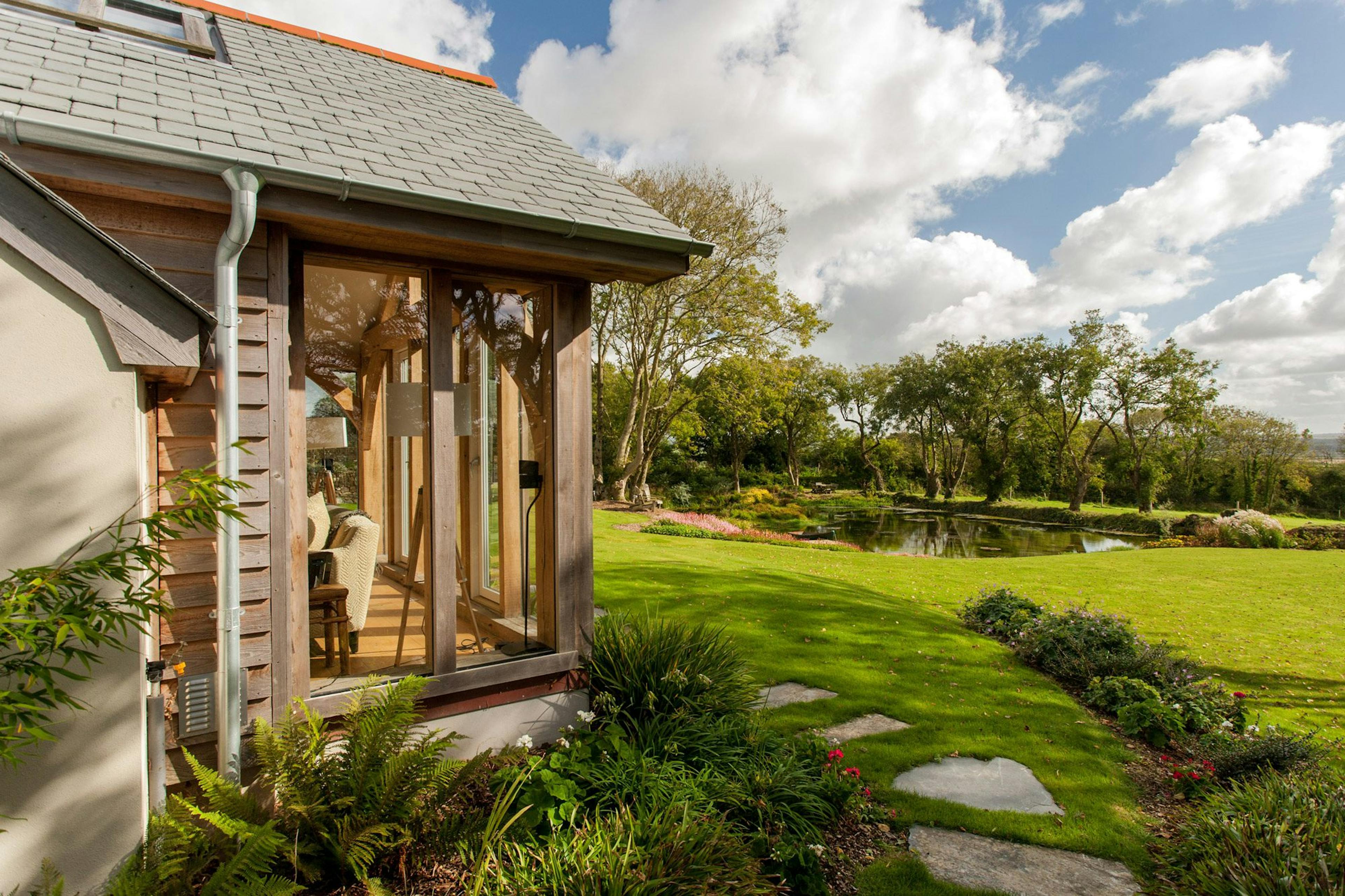 An oak-framed family home with scenic views of a picturesque garden and surrounding countryside