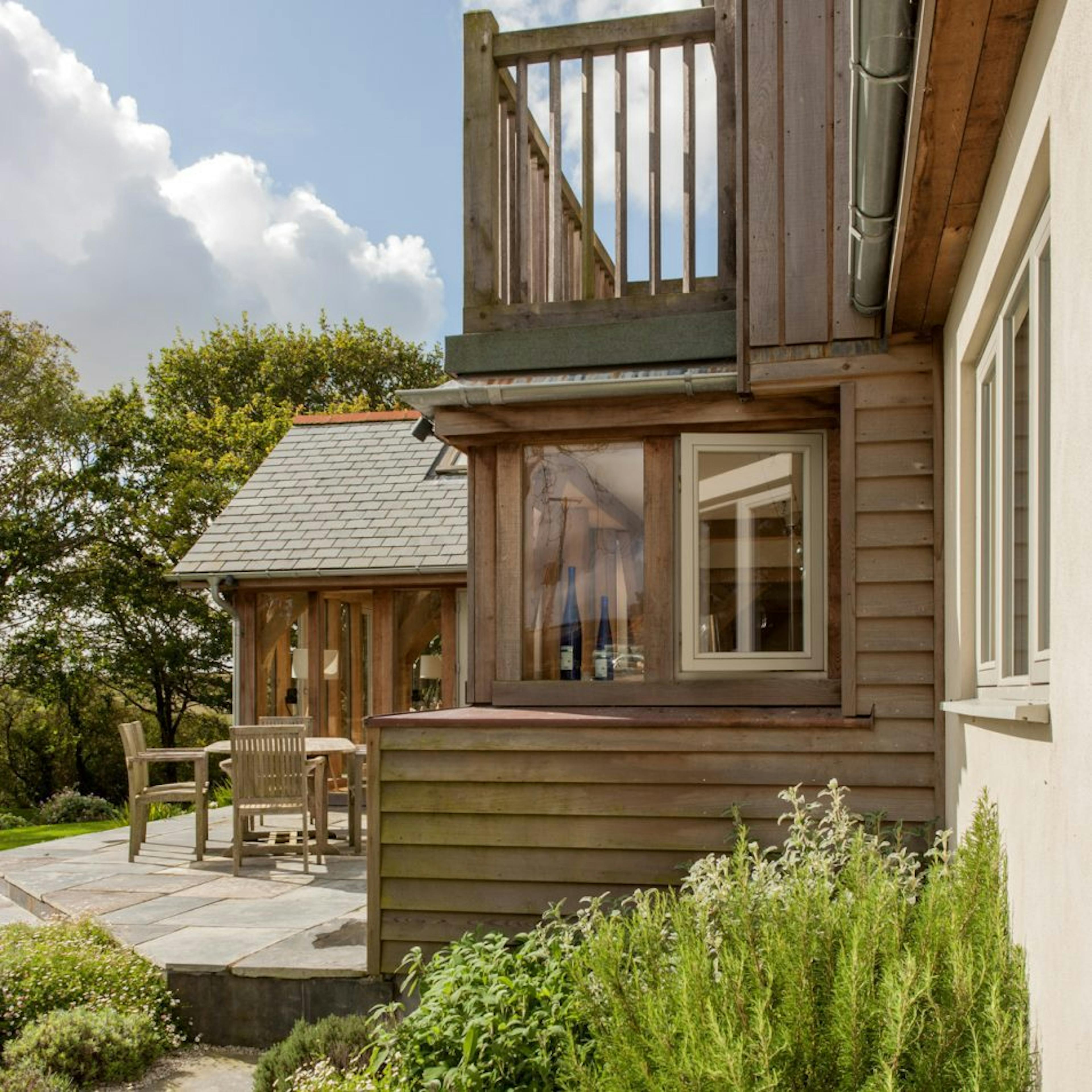 A charming oak-framed family home featuring an elegant patio garden, blending rustic style with outdoor living