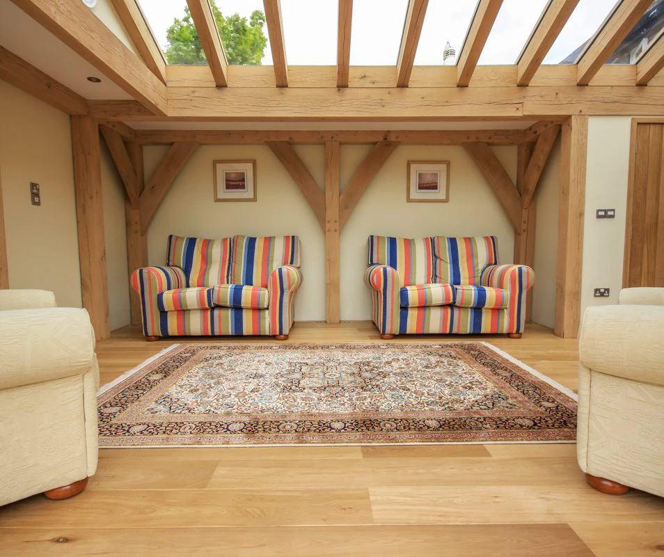 A warm and inviting oak-framed extension featuring a large roof lantern that brightens the space