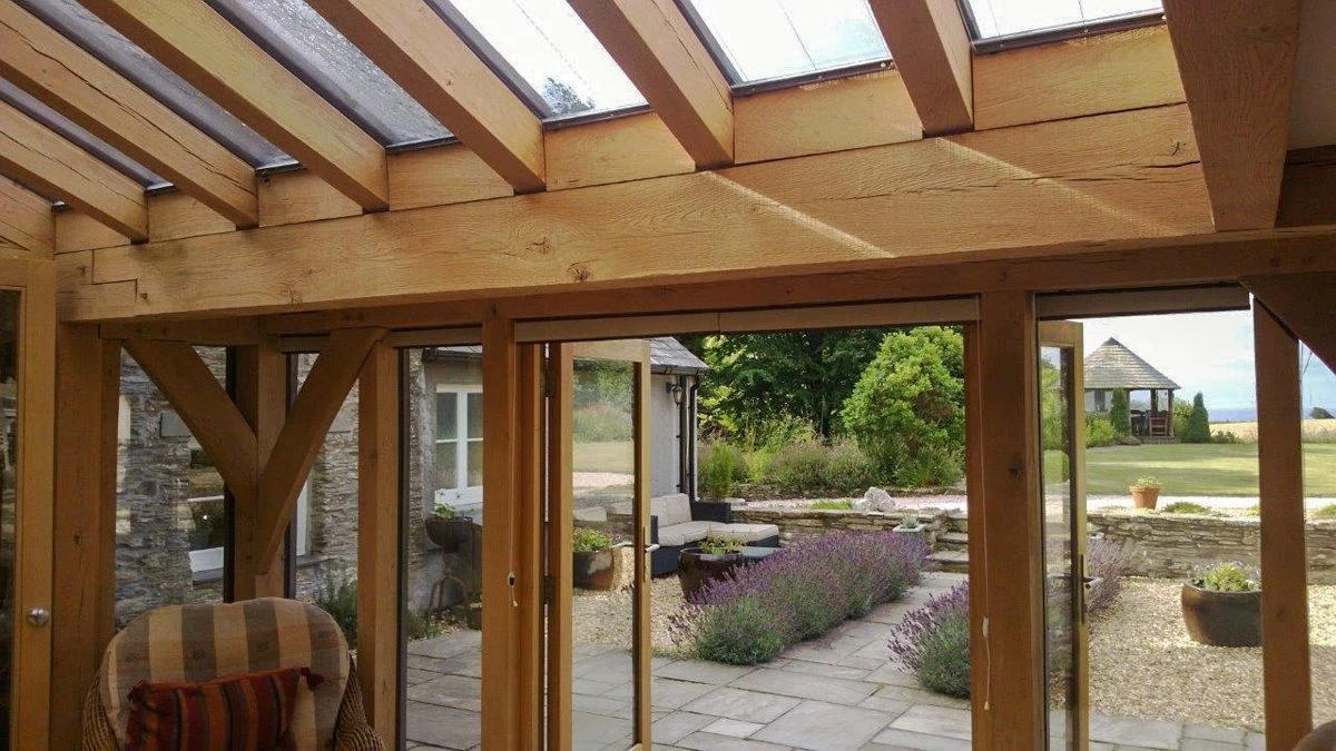 Oak-framed conservatory-style extension with large windows and a classic design