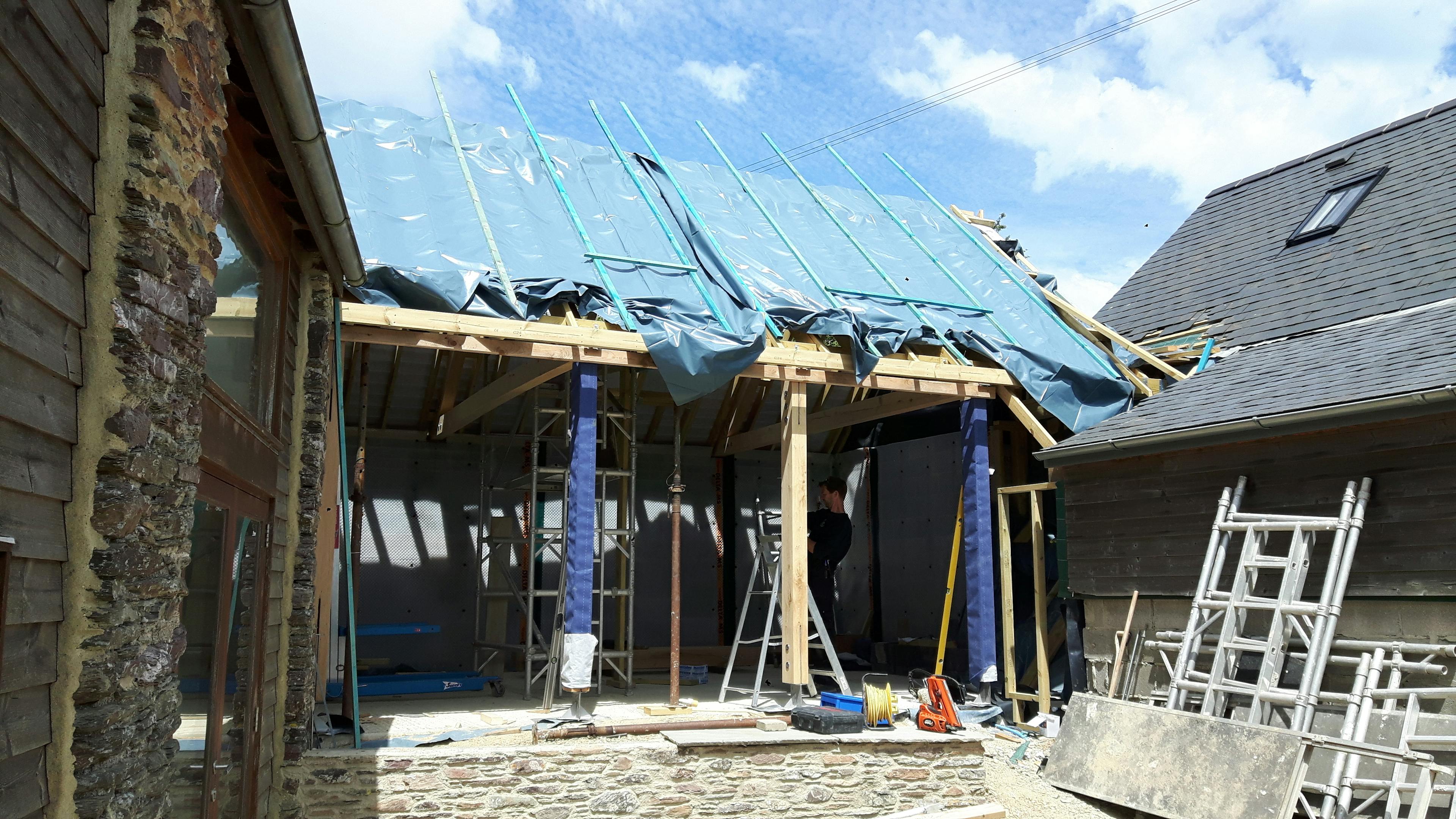 Oak-framed extension in the process of being wrapped and insulated