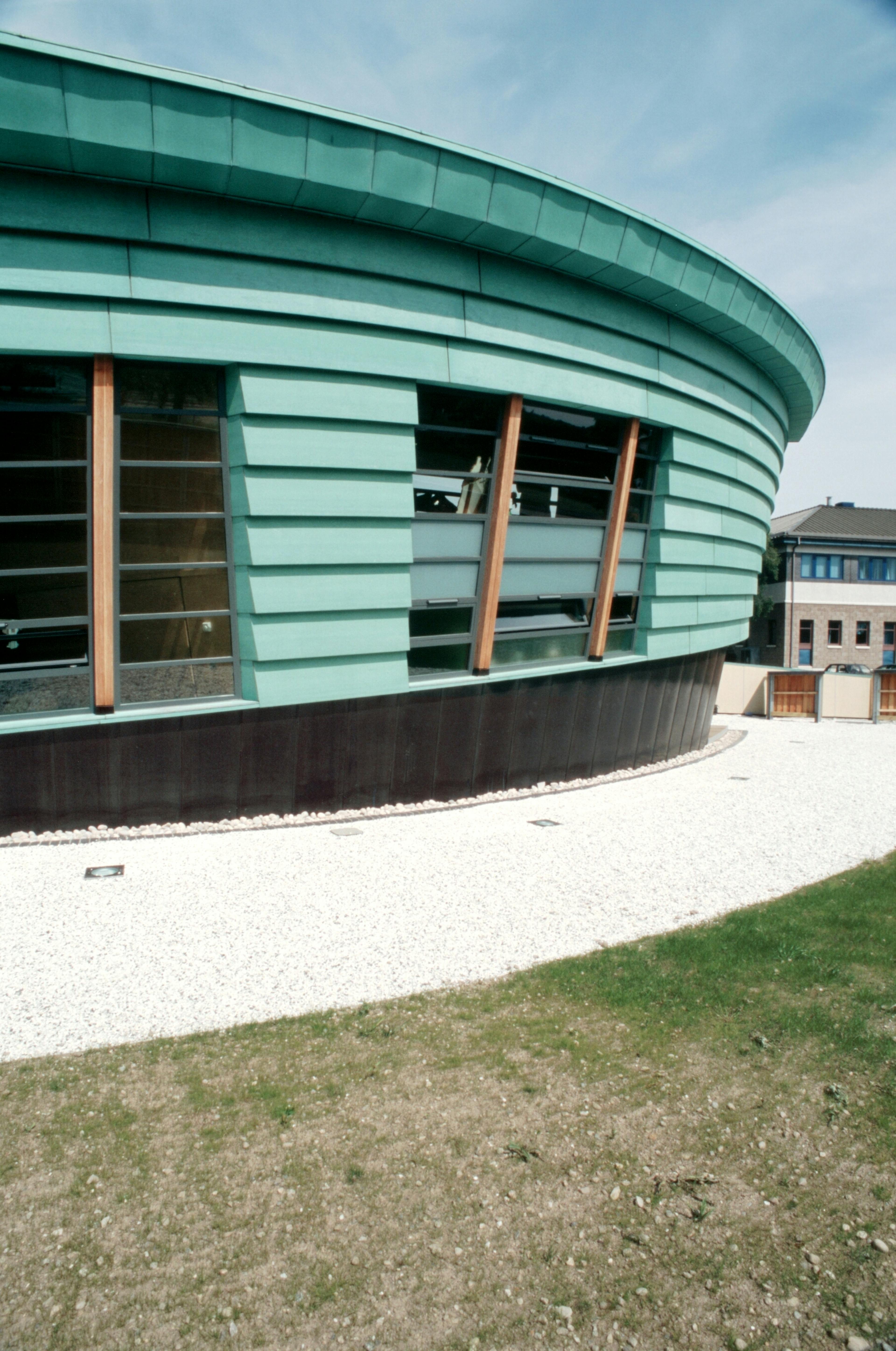 External view of Maggie's Centre at Raigmore Hospital in Inverness, constructed primarily from softwood with a sleek plywood exterior