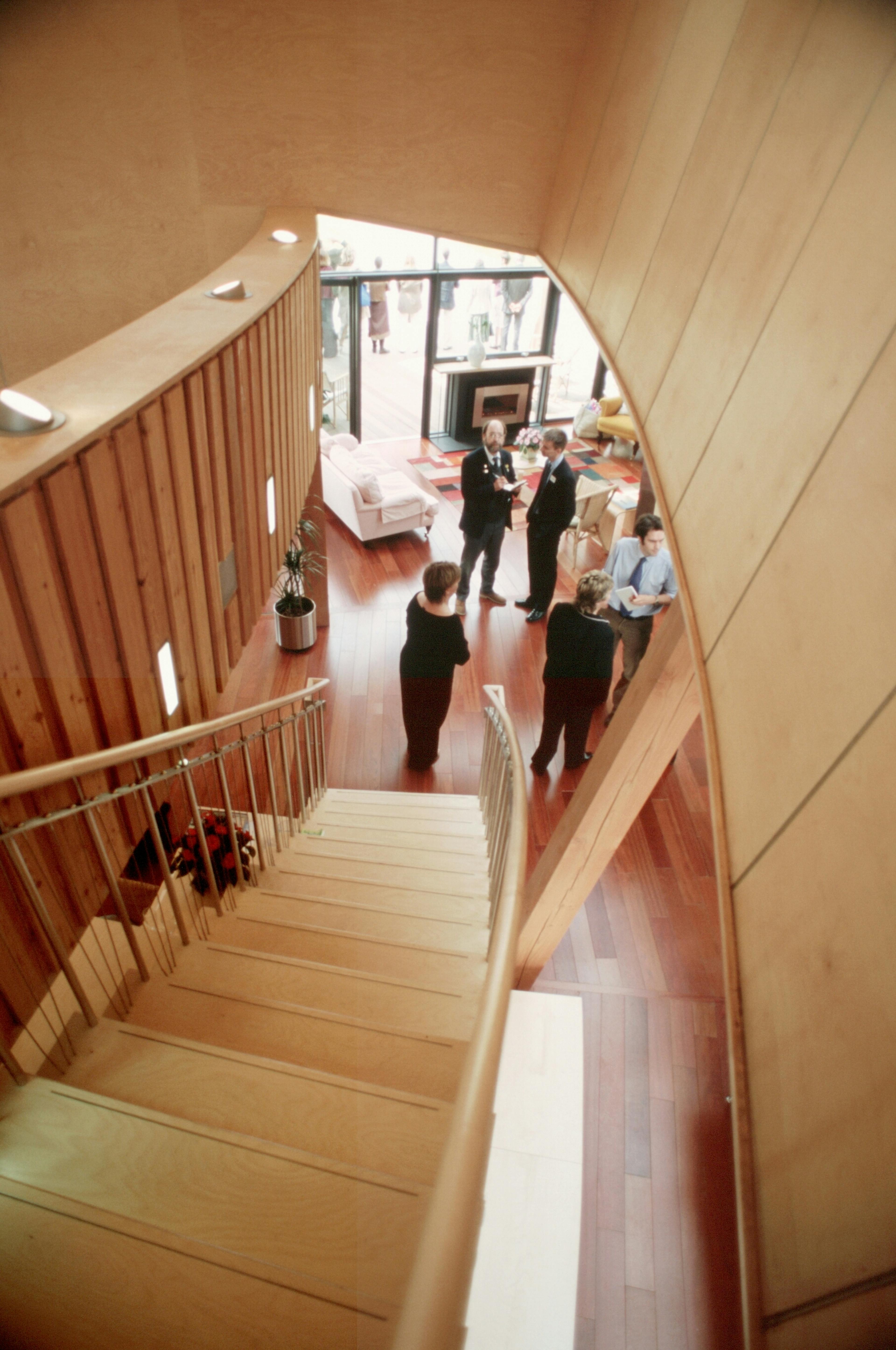 Curved staircase with a sleek plywood skin inside the Maggie's Centre at Raigmore Hospital