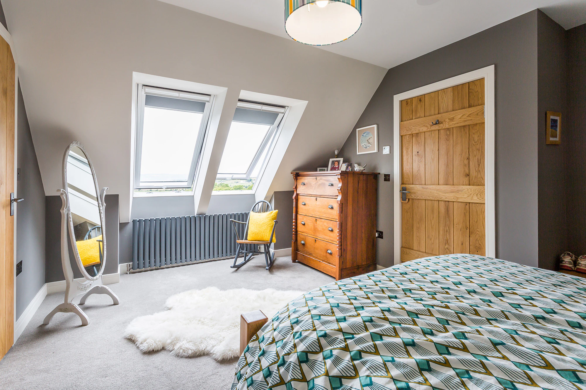 Spacious bedroom inside an oak-framed family home with a cozy, modern design