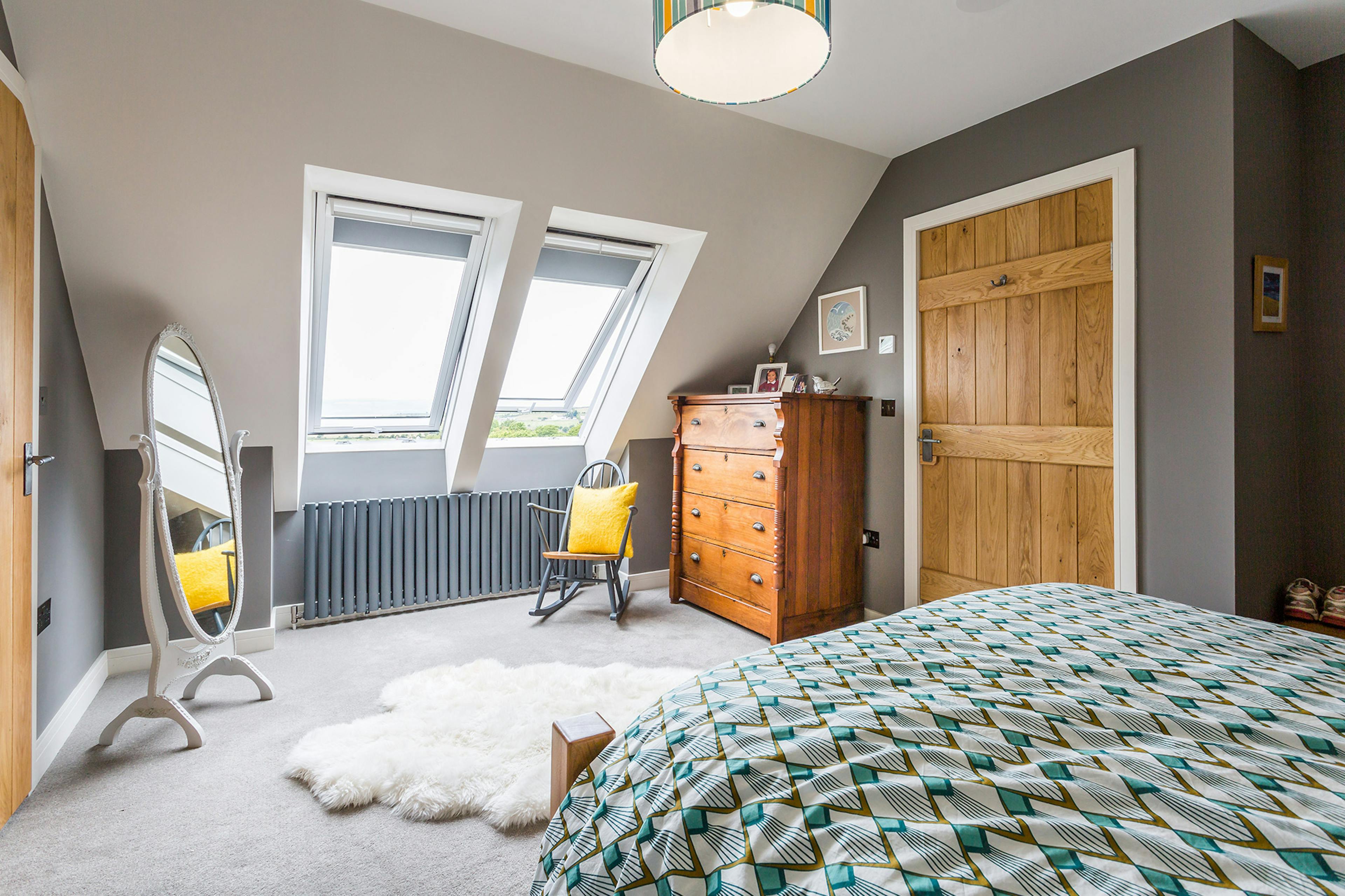 Spacious bedroom inside an oak-framed family home with a cozy, modern design