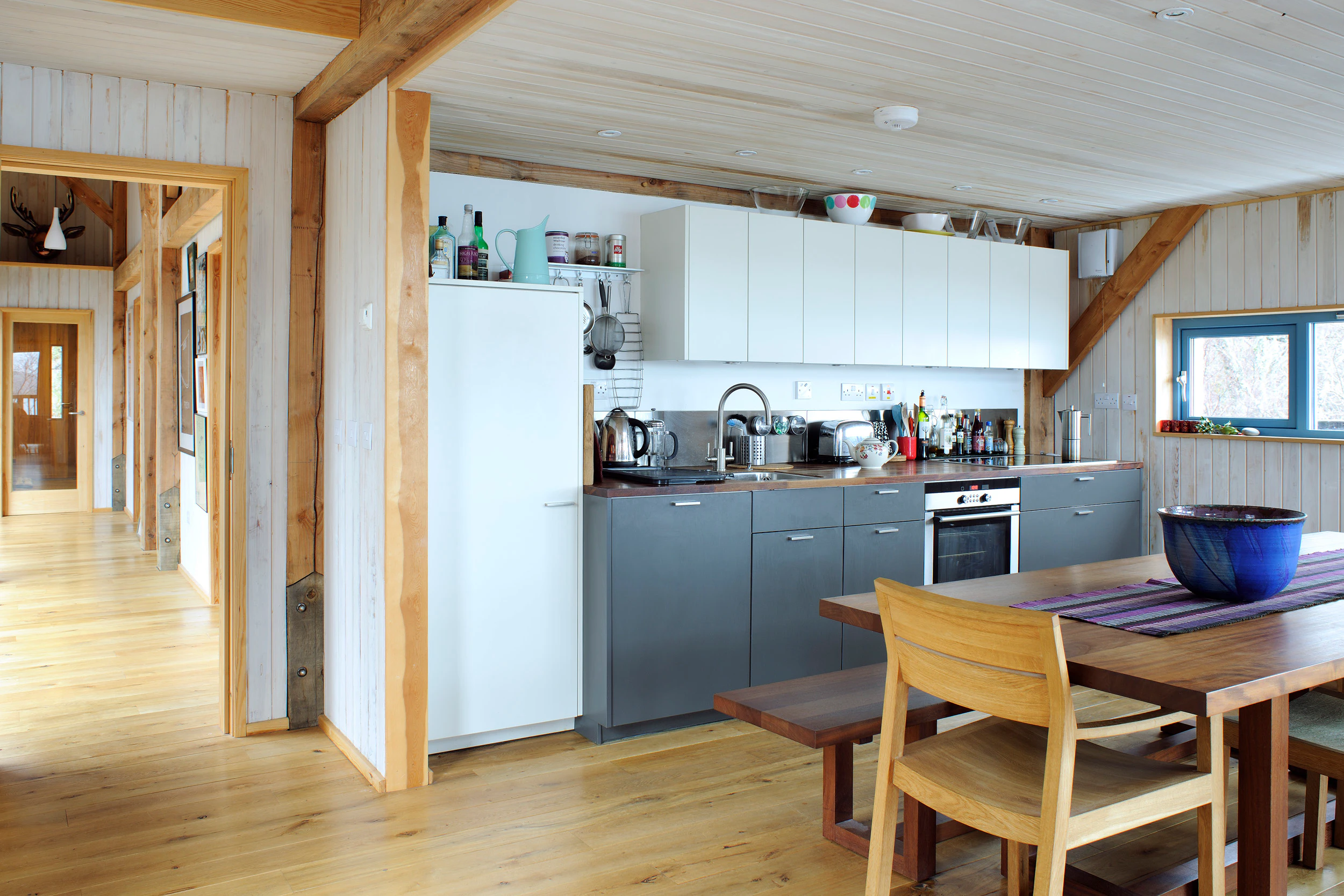 Internal view of a Douglas-fir framed home featuring an open-plan kitchen and living area