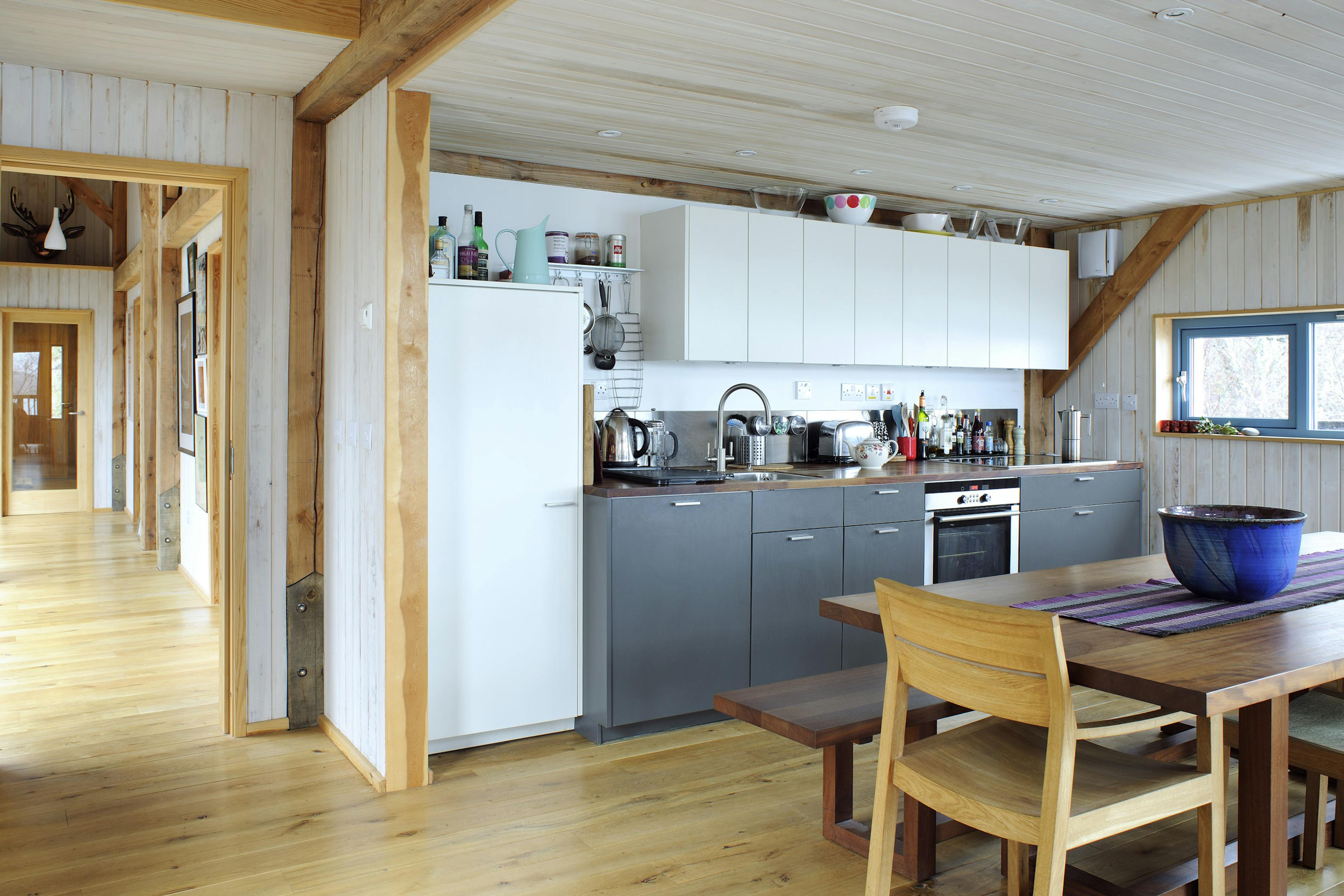 Internal view of a Douglas-fir framed home featuring an open-plan kitchen and living area