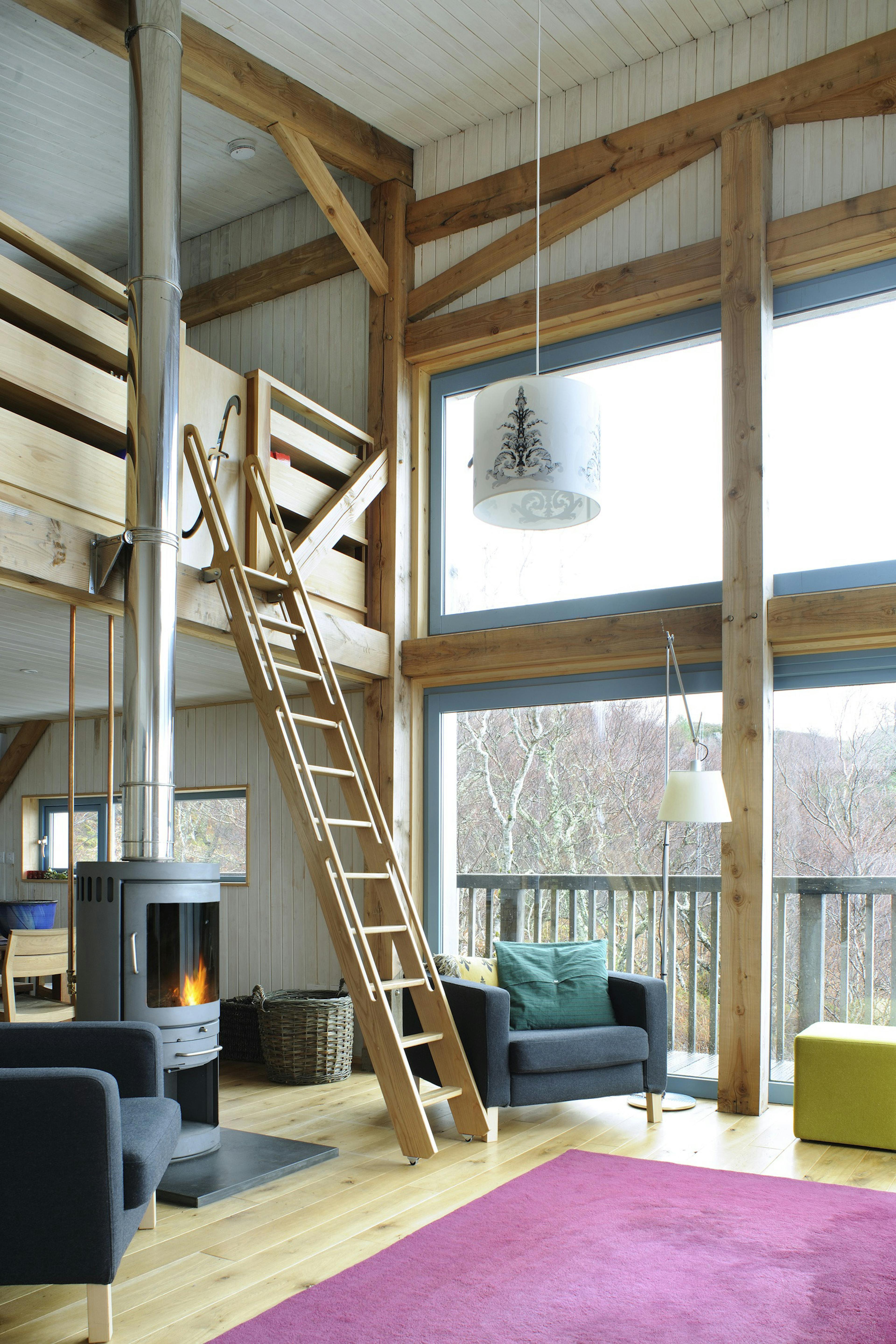 Internal view of a Douglas-fir framed living space with vaulted ceilings and a view overlooking the mezzanine