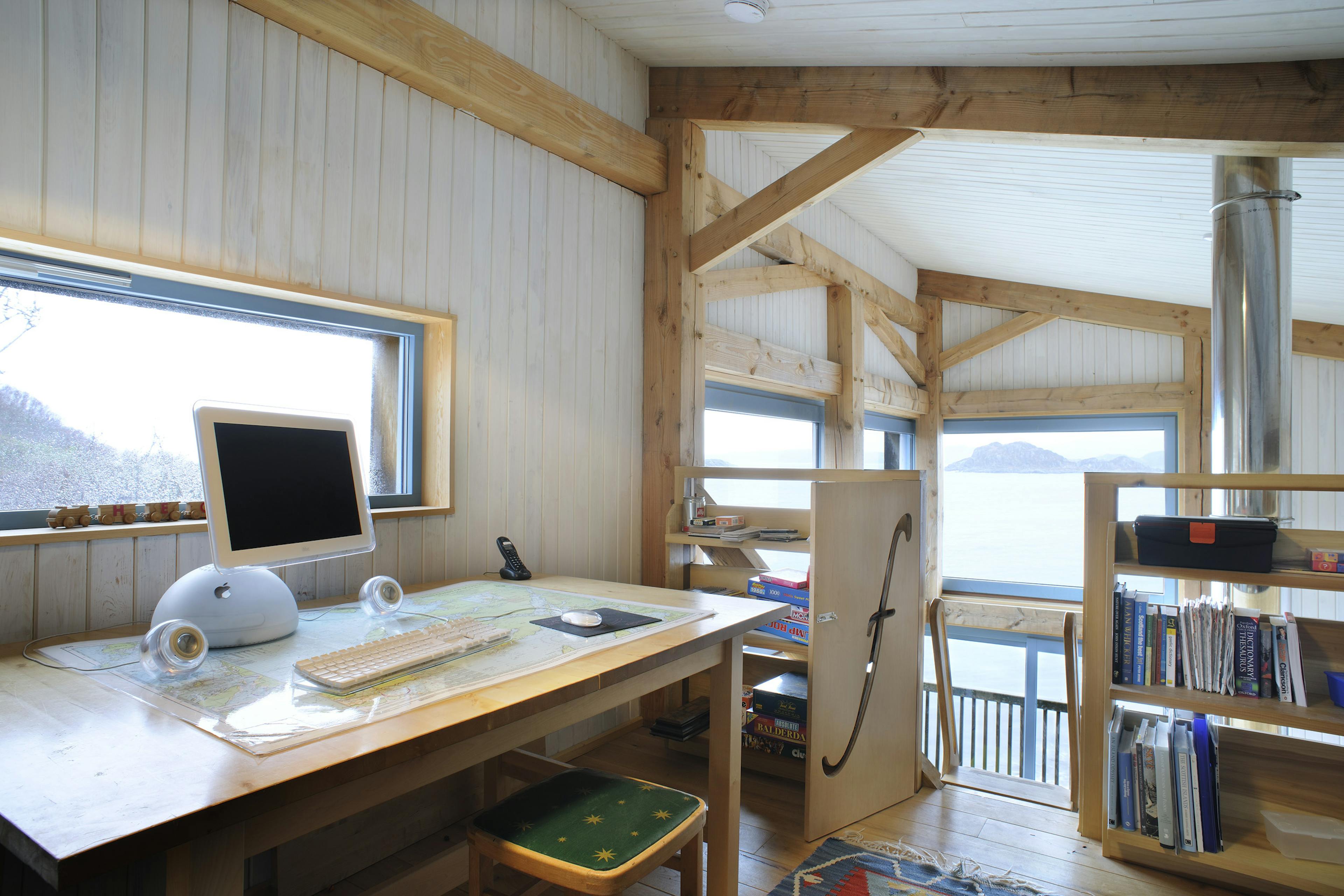 Internal view of a Douglas-fir framed living space featuring an open mezzanine with a dedicated office area