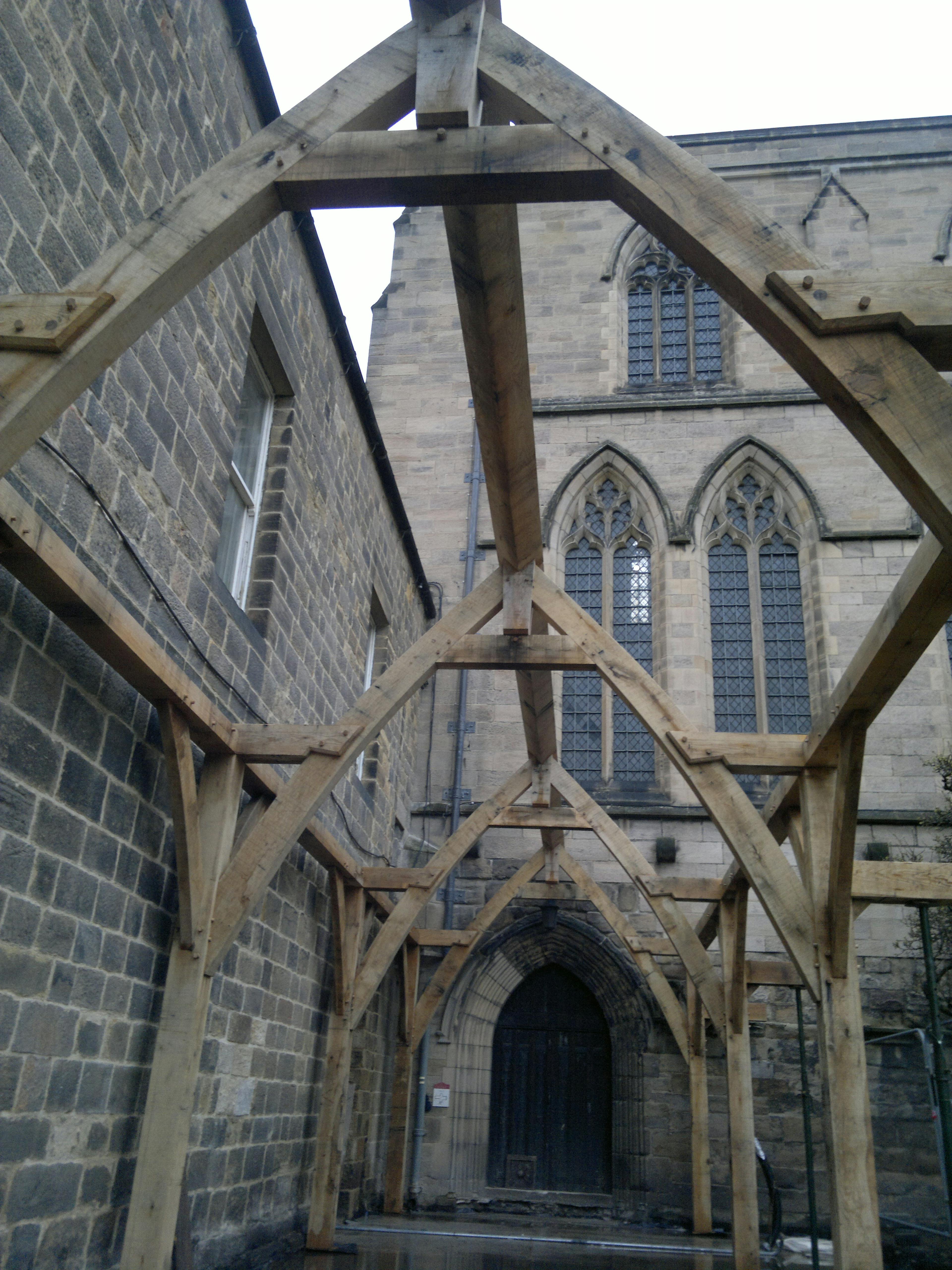 Installation in progress for the oak-framed cloister