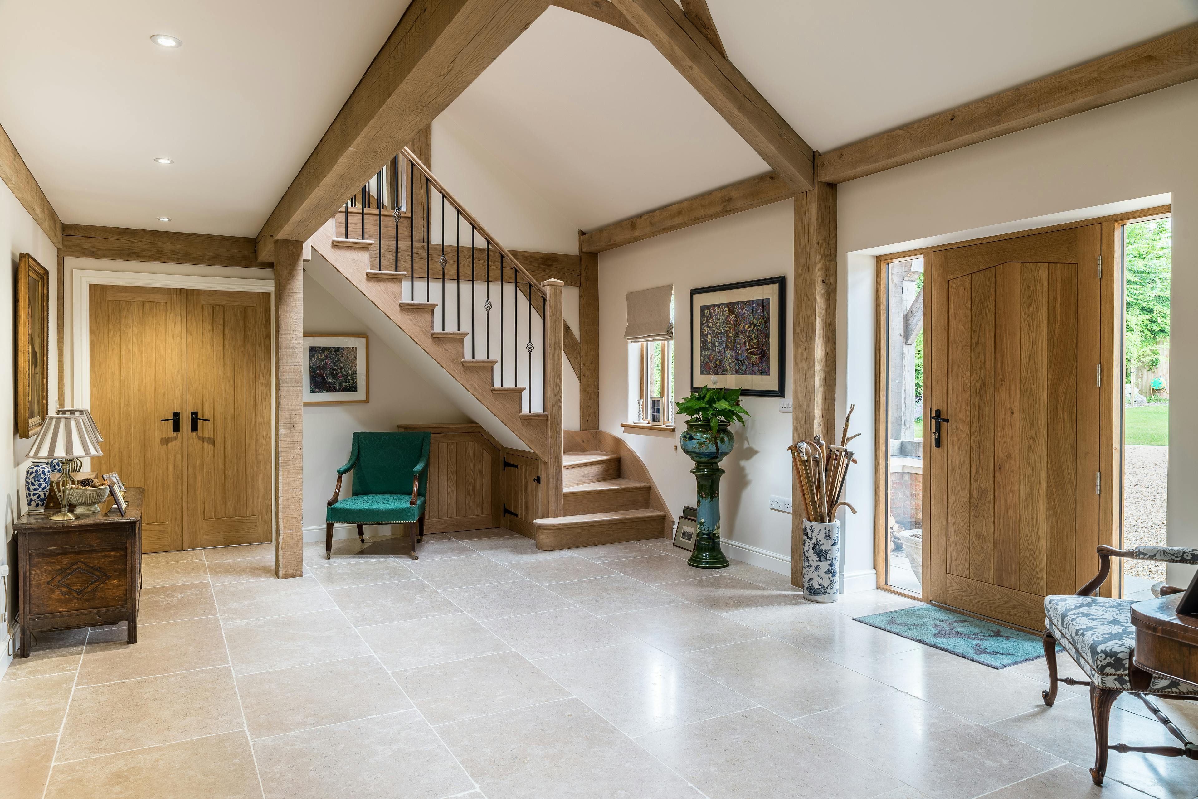 Internal view of an open foyer in an oak-framed family home, featuring a spacious and inviting design