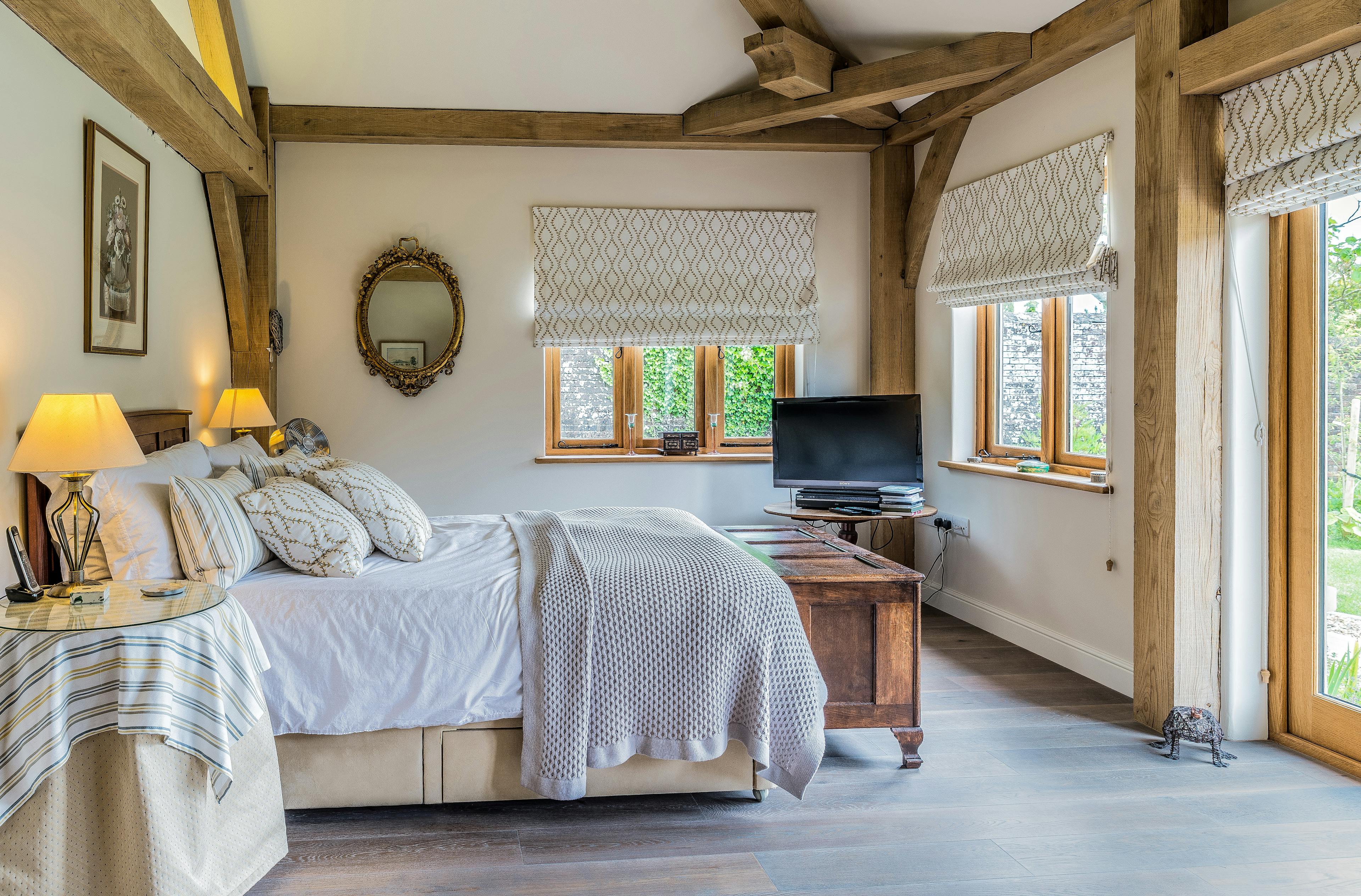 Master bedroom in an oak-framed family home, combining comfort and timeless design