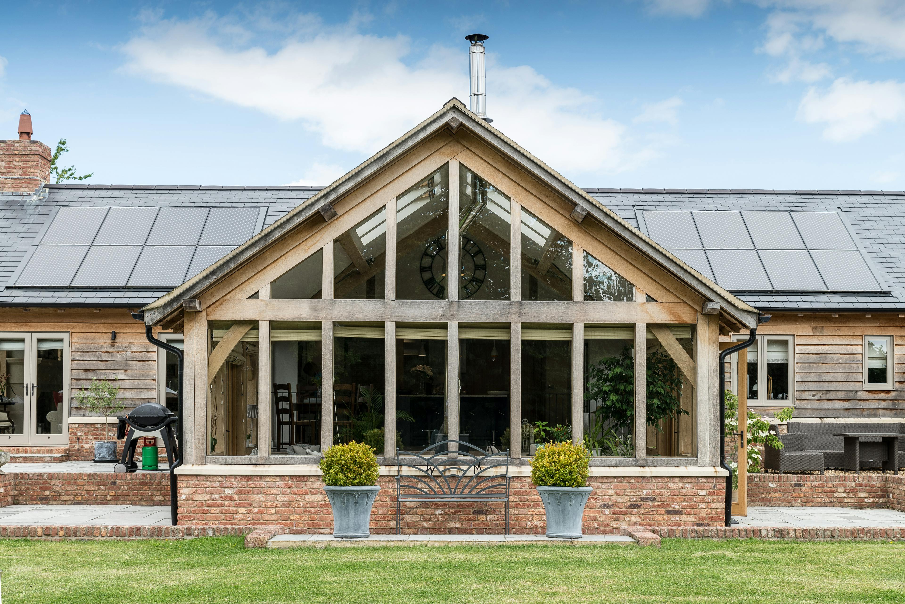 External view of a glazed gable end featuring a modern direct glazing system