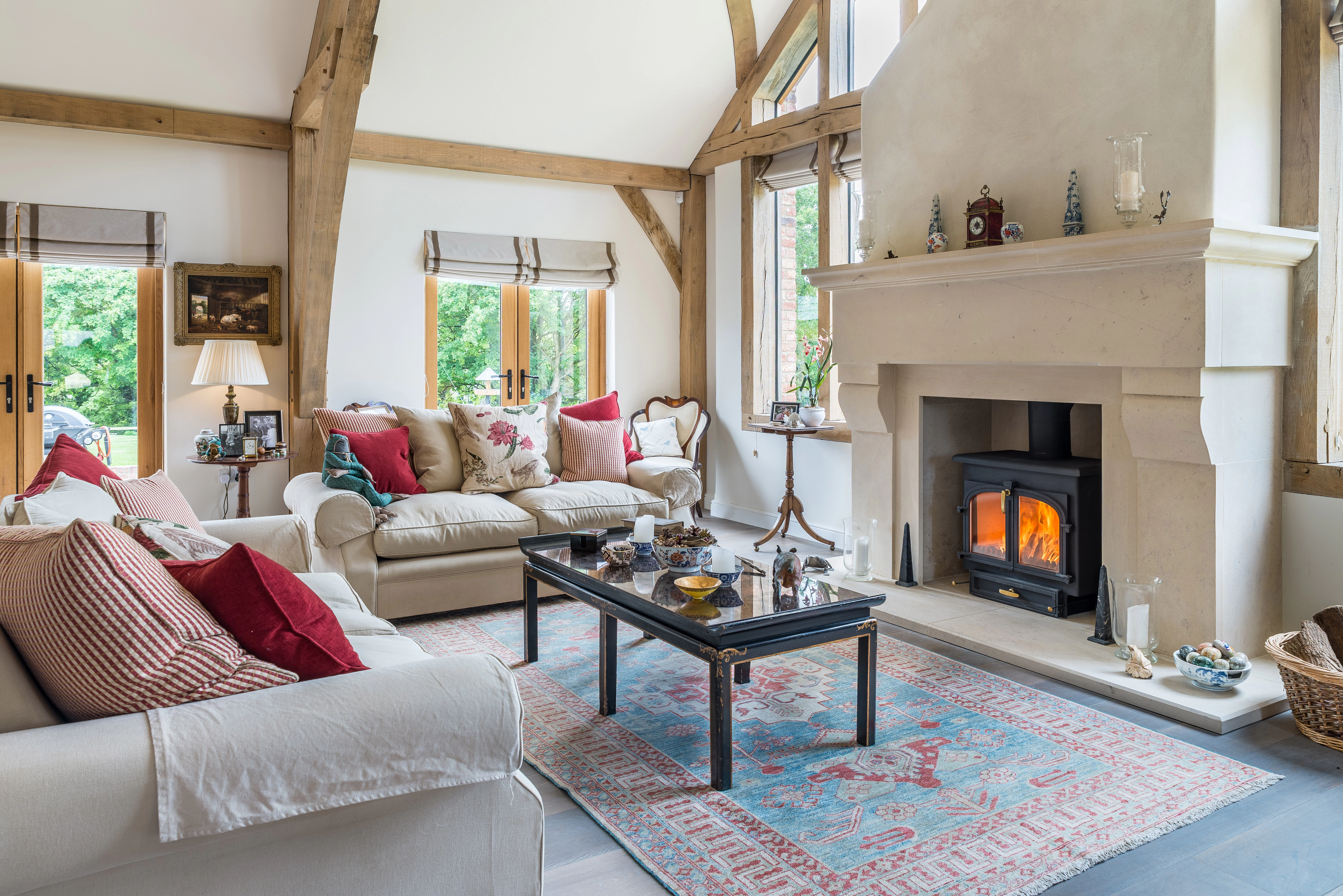 Internal view of a lounge featuring vaulted ceilings, a glazed gable end, and a central fireplace