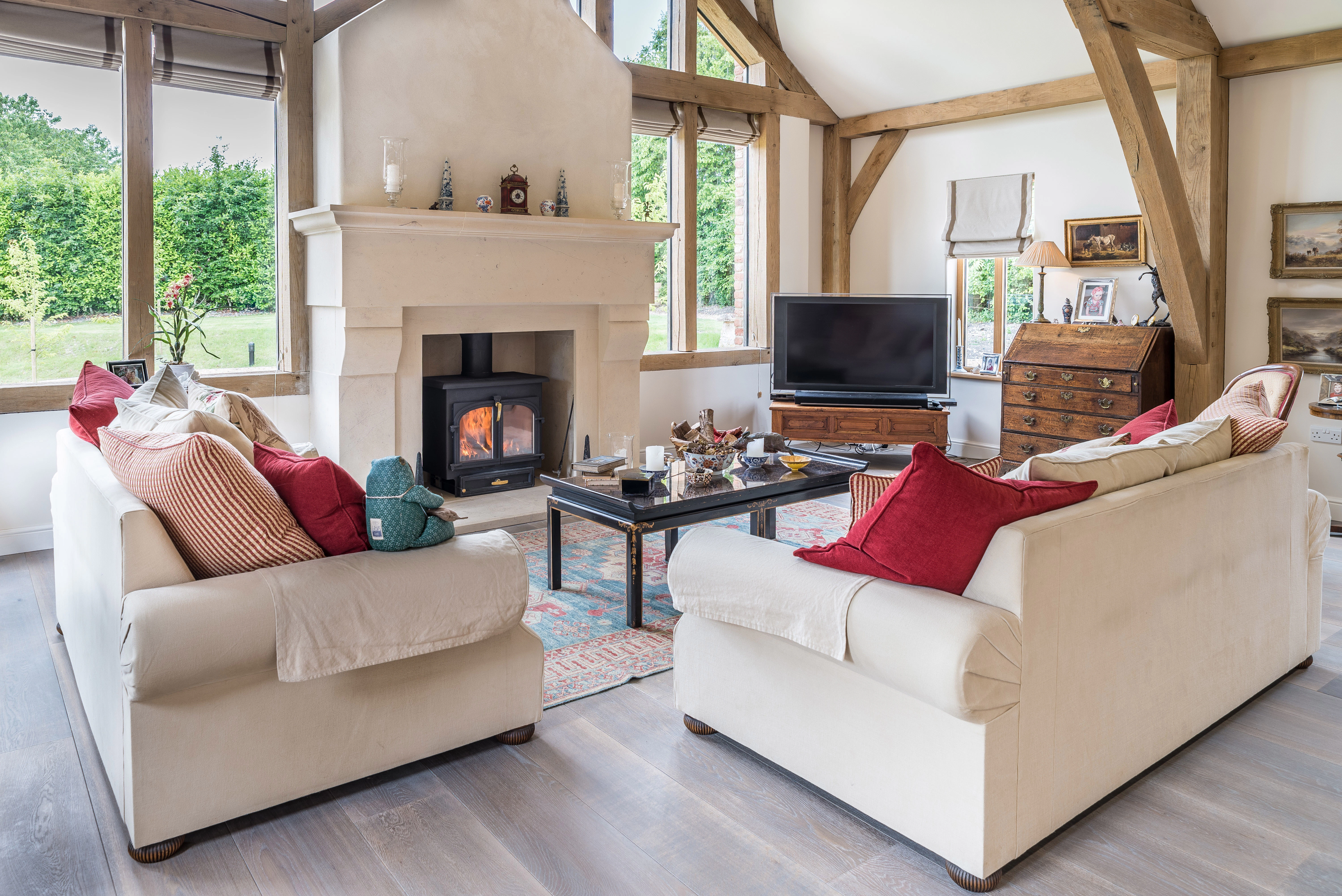 Internal view of a lounge featuring vaulted ceilings, and a central fireplace