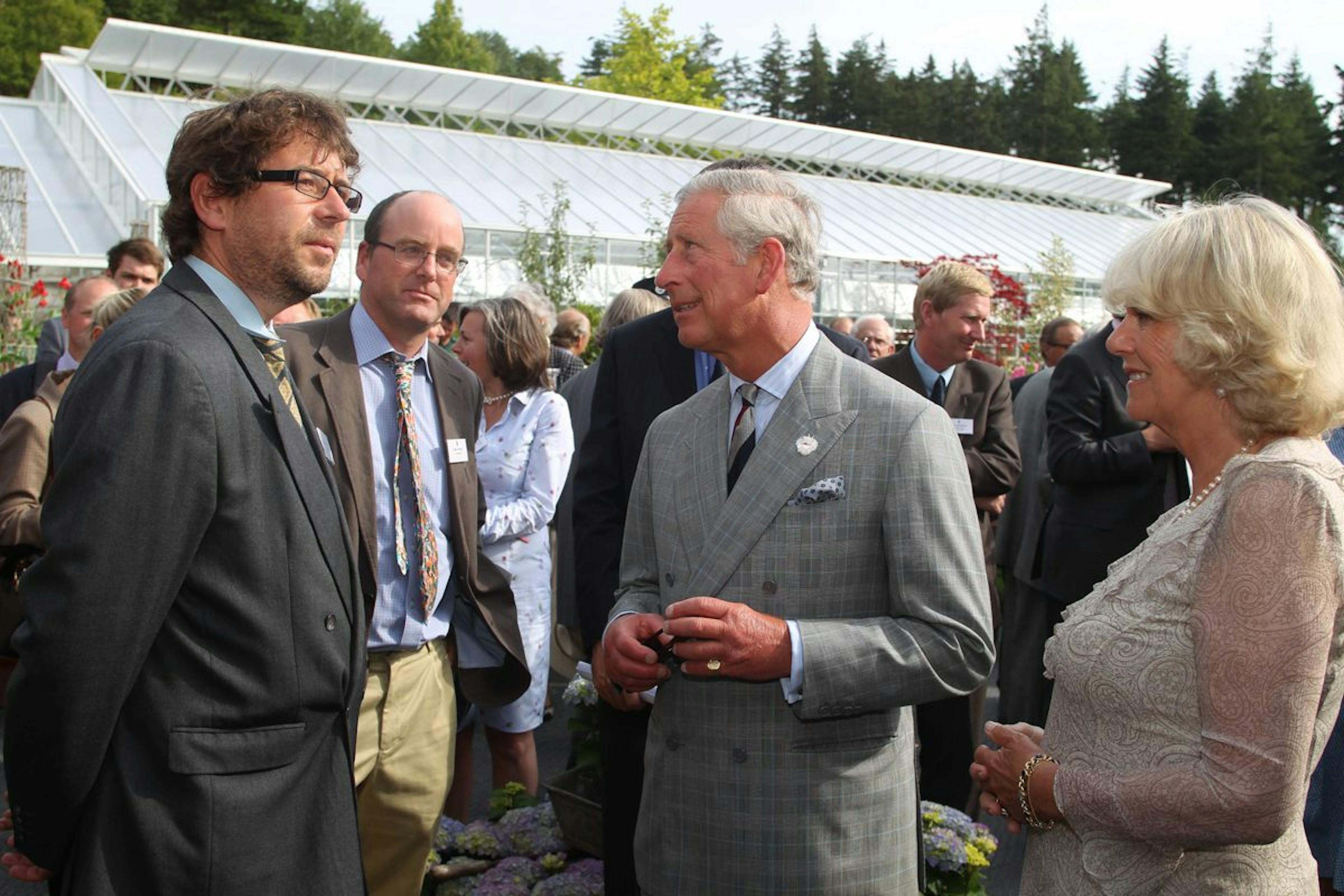 His Royal Highness the Prince of Wales and Camilla, Duchess of Cornwall at the opening of an oak framed building at the Duchy of Cornwall garden nursery meeting Carpenter Oak employees Paul Slemmings and Adam Milton