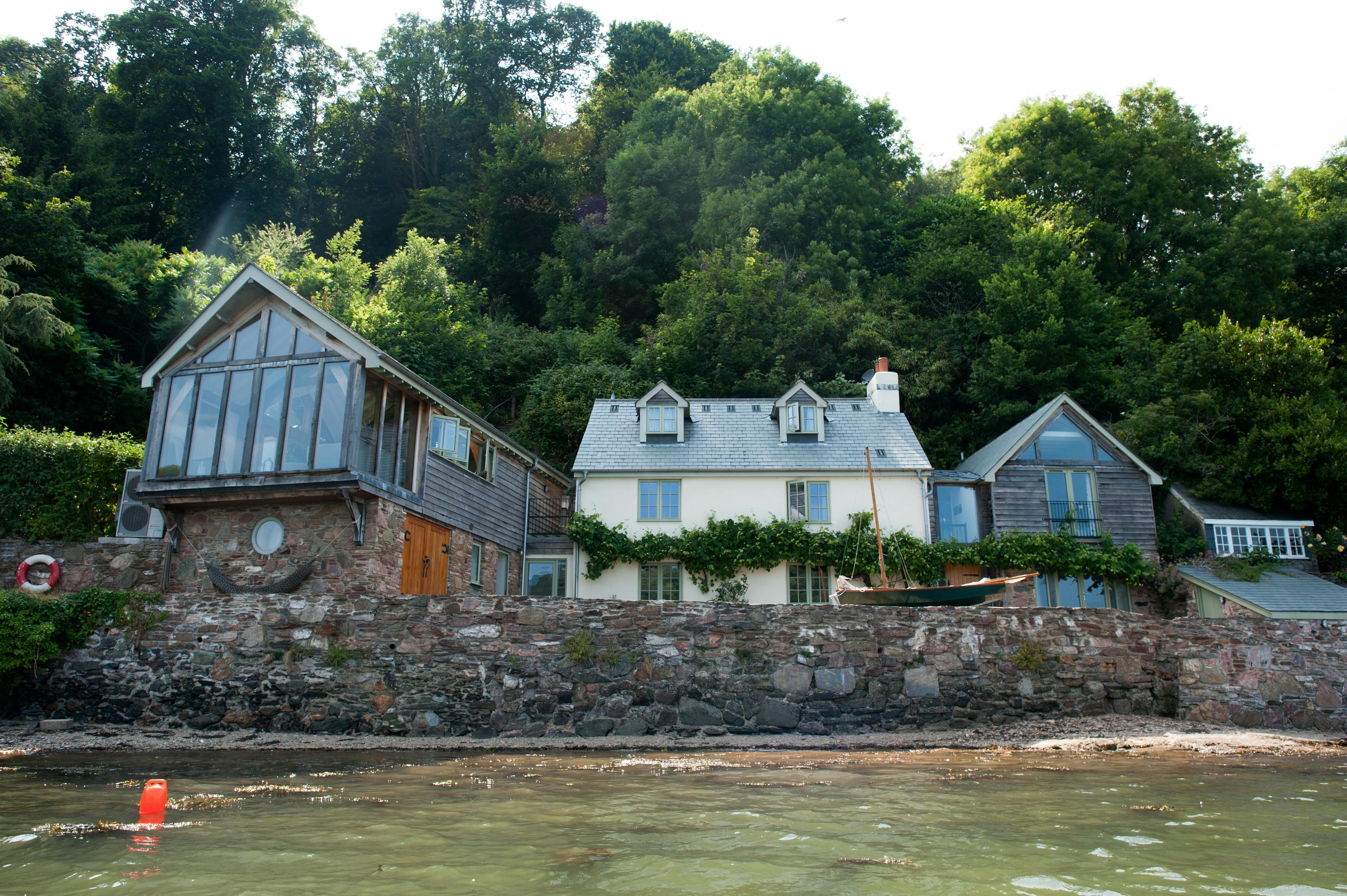 An oak-framed cottage situated on the edge of an estuary