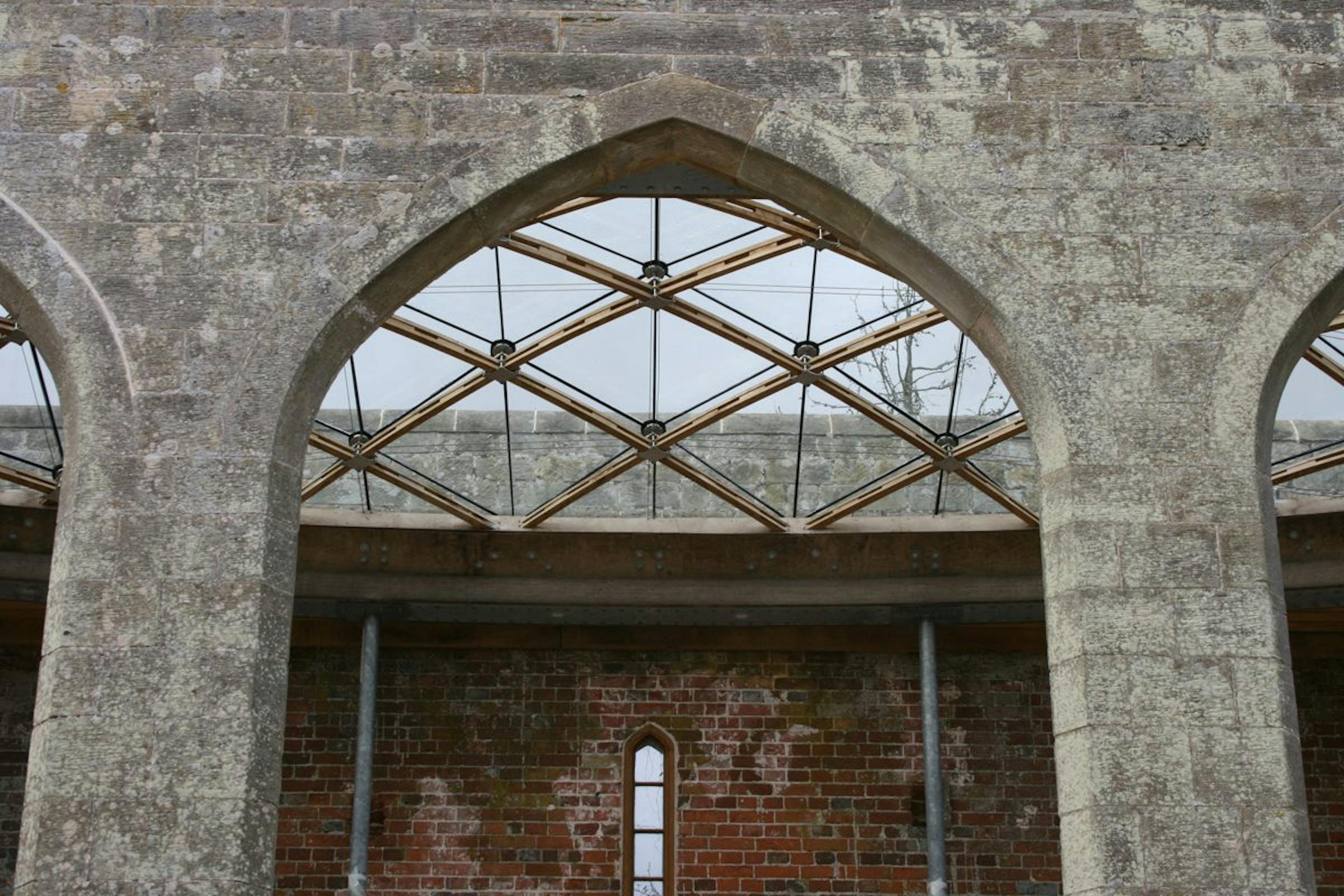 A glazed timber frame gridshell structure designed for a historic orangery at Chiddingstone Castle, Kent