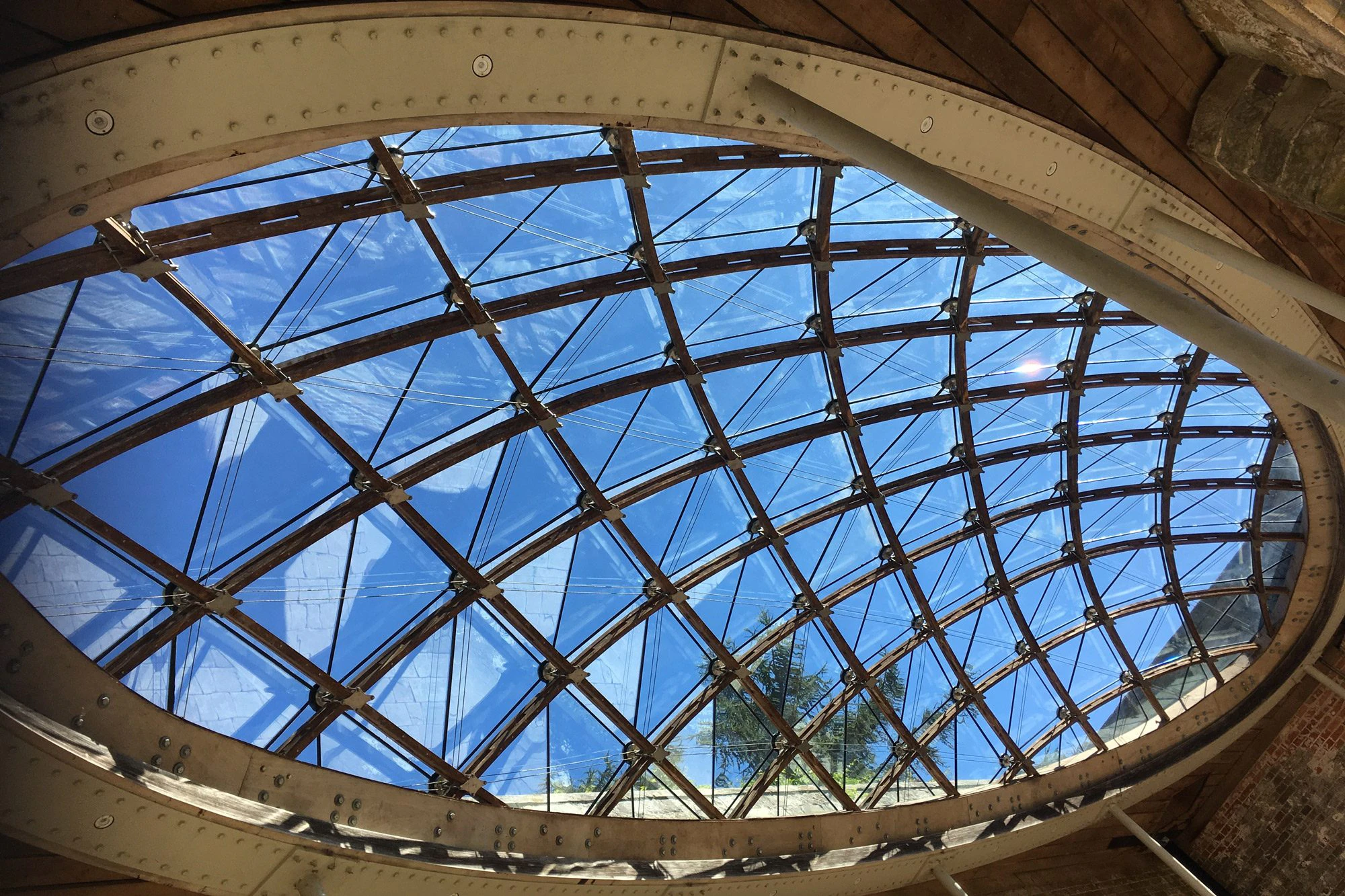A glazed timber frame gridshell structure designed for a historic orangery at Chiddingstone Castle, Kent