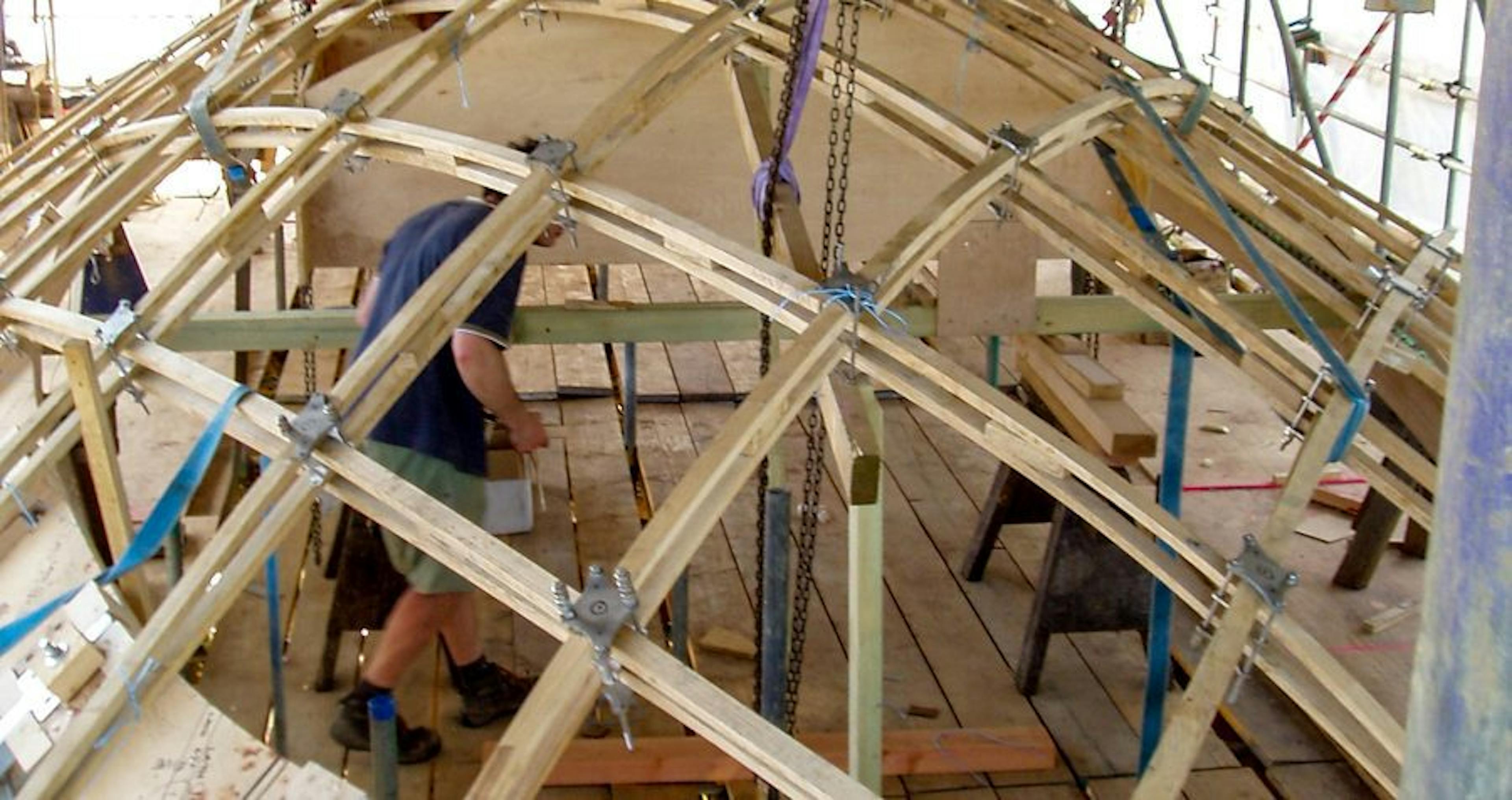 The complex installation of a glazed timber frame gridshell roof for a historic orangery building
